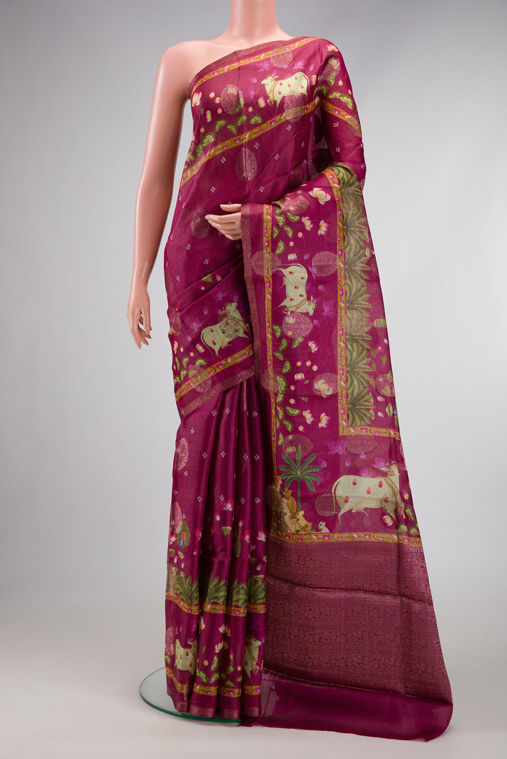 Maroon Tussar Silk Saree with Printed design on the body and Fancy Border.  displayed on a mannequin
