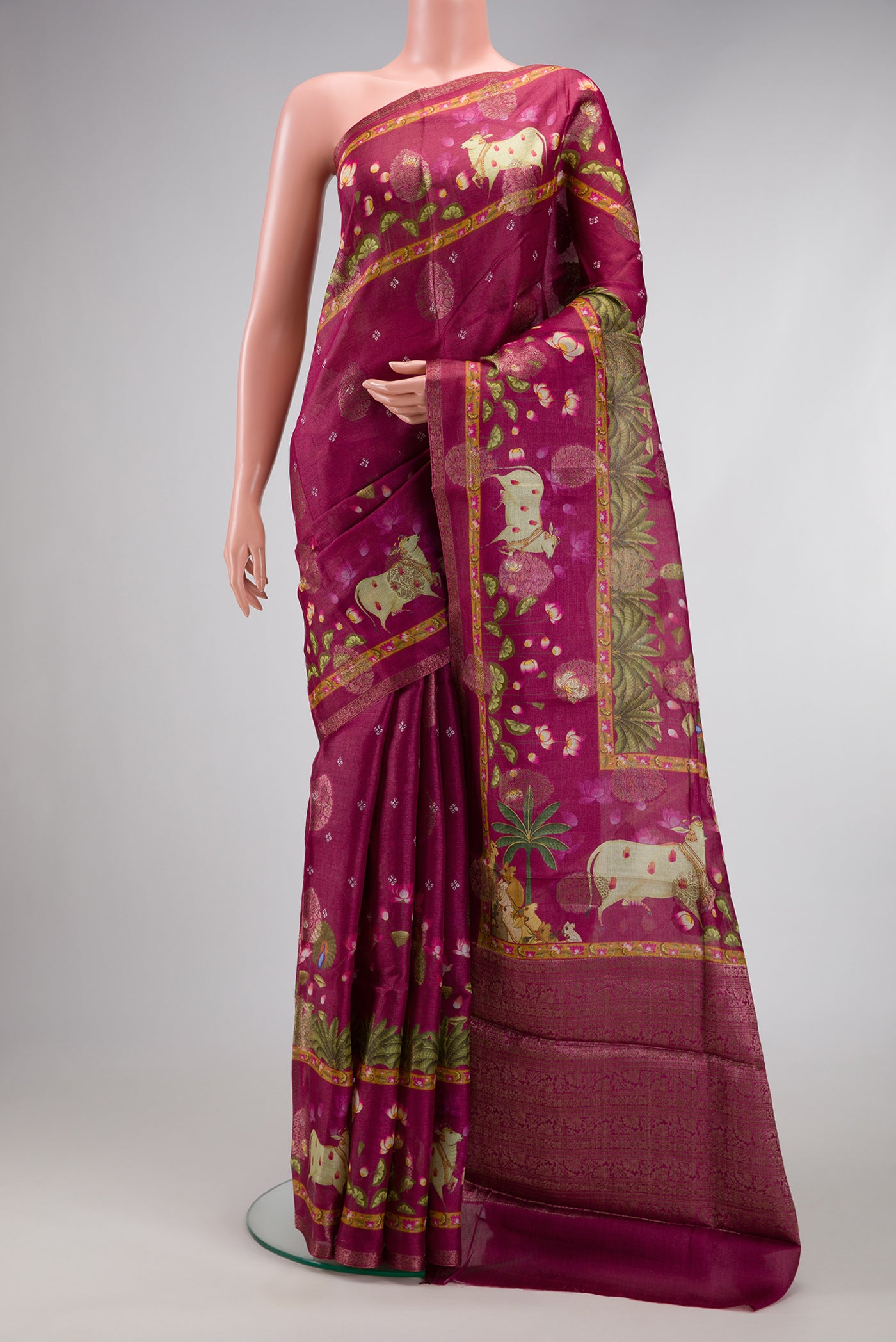 Maroon Tussar Silk Saree with Printed design on the body and Fancy Border.  displayed on a mannequin