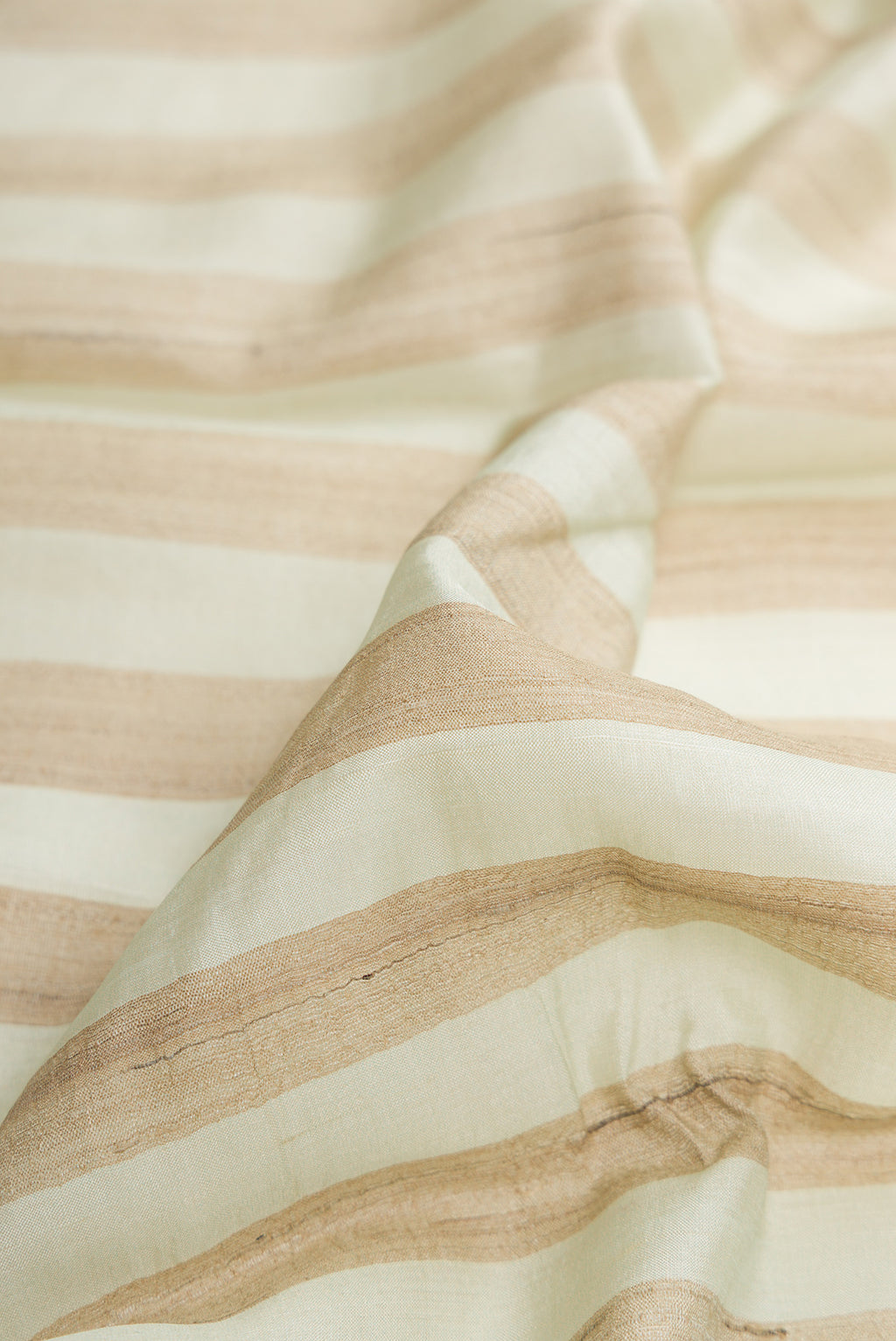 Close up of Pista Green Dual Tone Tussar Silk Saree with Stripes on the body and Fancy Border.  displaying folds