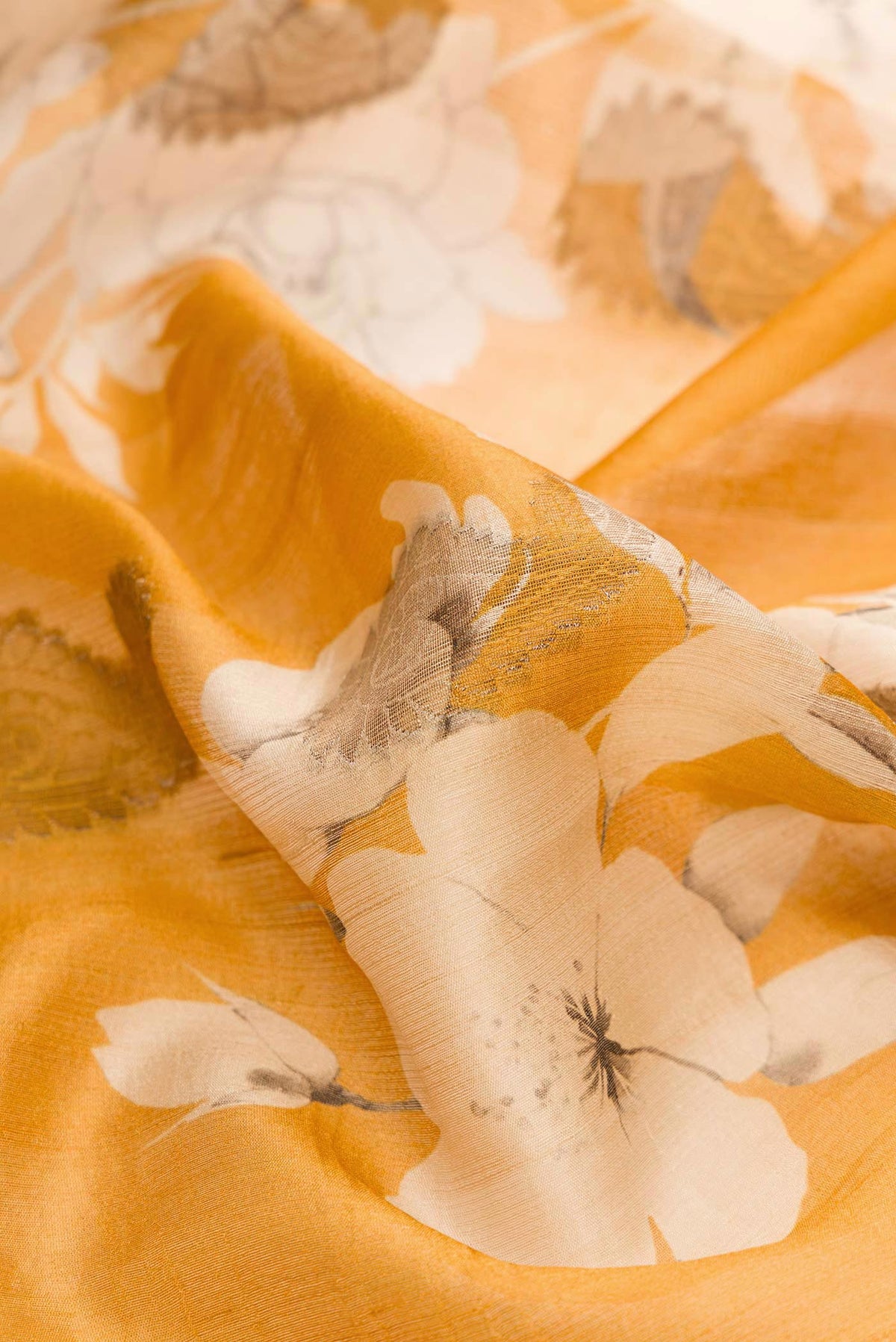 Close up of Yellow Dual Tone Tussar Silk Saree with Printed design on the body and Zari Border displaying folds