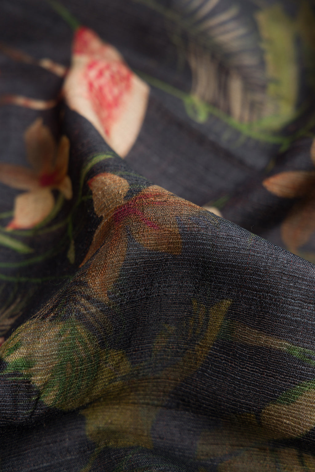 Close up of Black Dual Tone Tussar Silk Saree with Printed design on the body and Zari Border.  displaying folds