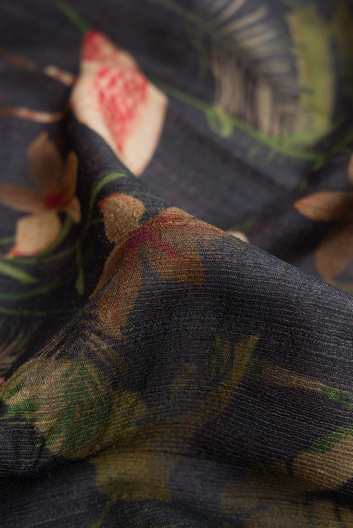 Close up of Black Dual Tone Tussar Silk Saree with Printed design on the body and Zari Border.  displaying folds