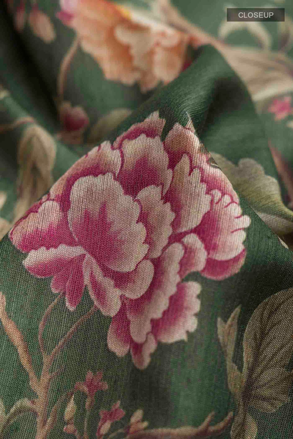 Close up of Green Bhagalpuri Tussar Silk Saree with Printed design on the body and Checks Border displaying folds