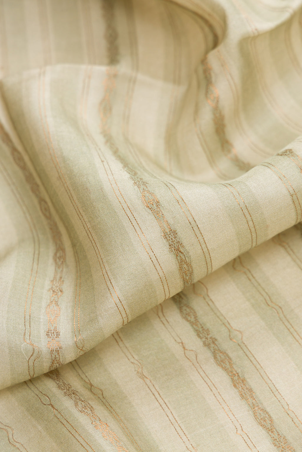 Close up of Pista Green Dual Tone Tussar Silk Saree with Printed design on the body and Printed Border.  displaying folds