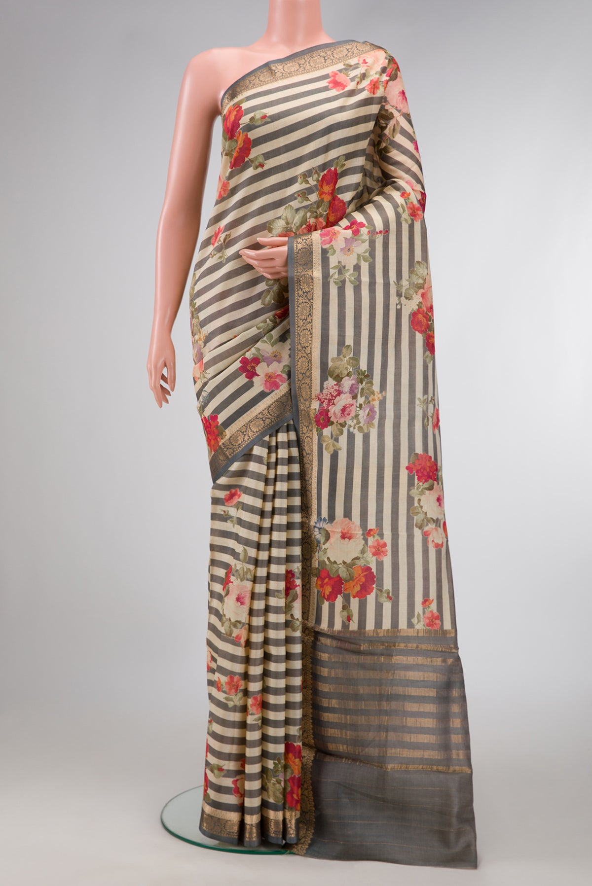 Beige and Grey Color Tussar Silk Saree with Printed design on the body and Zari Border.  displayed on a mannequin