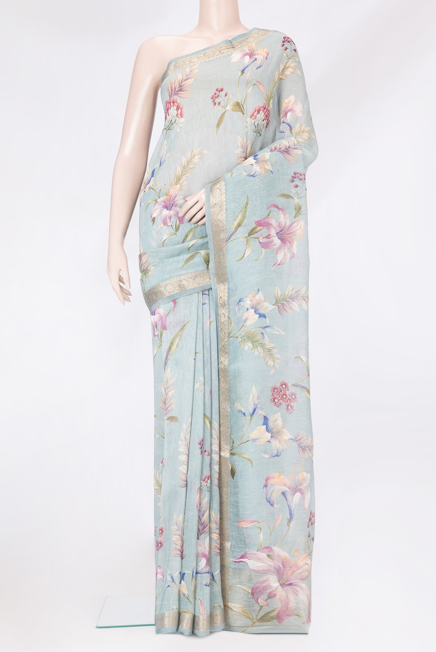 Grey Linen Saree with Floral Print on the body and Zari Border.  displayed on a mannequin