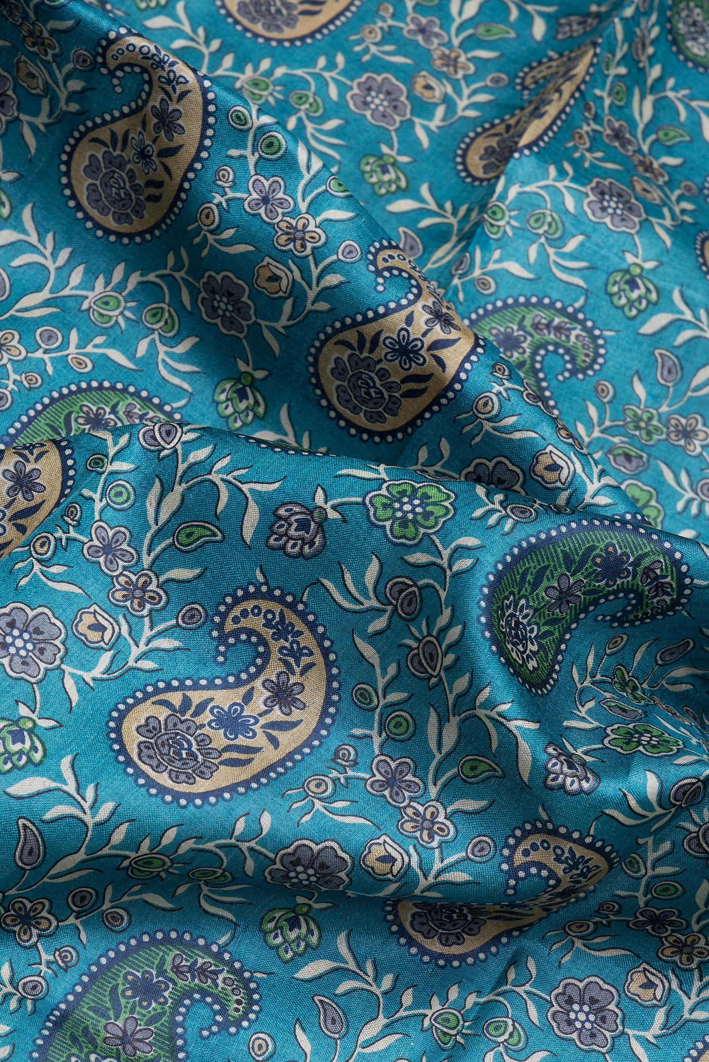 Close up of Sky Blue Tussar Silk Saree with Printed design on the body and Printed Border.  displaying folds