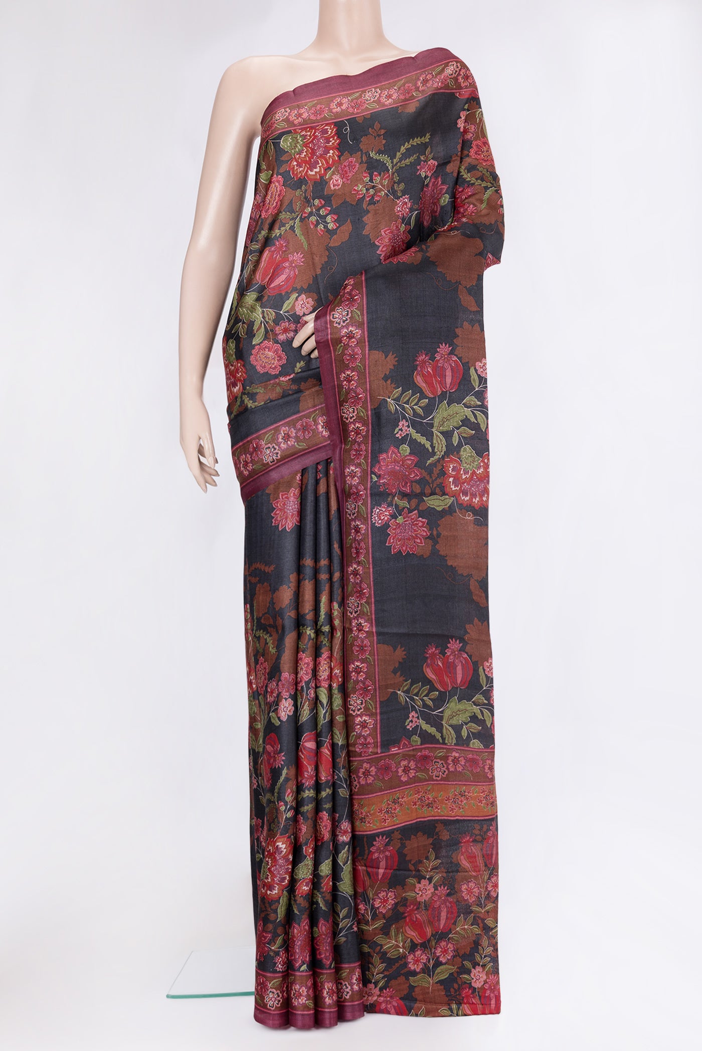 Black Tussar Silk Saree with Floral Print on the body and Printed Border.  displayed on a mannequin