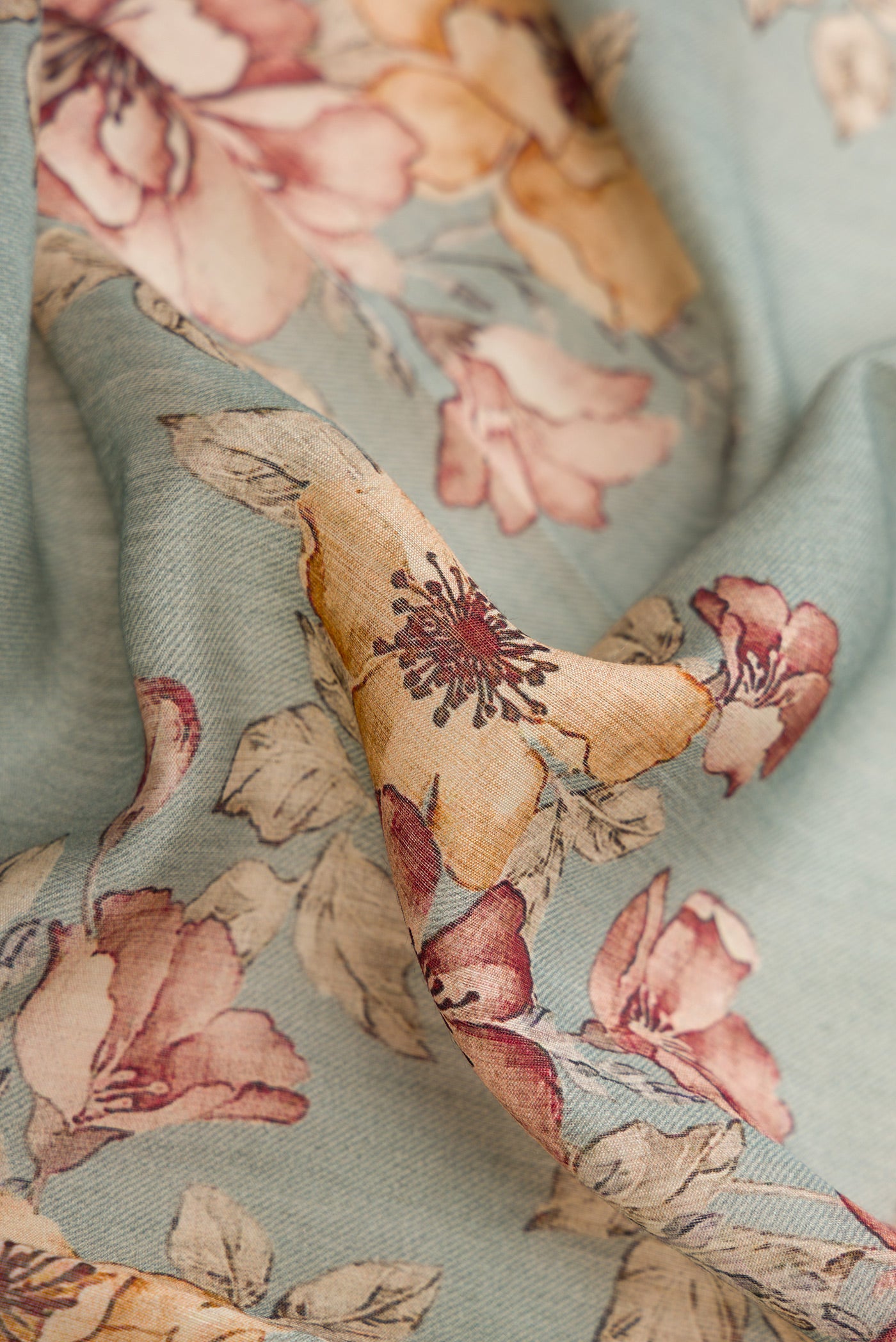 Close up of Grey Dual Tone Tussar Silk Saree with Printed design on the body and Embroidery Border.  displaying folds