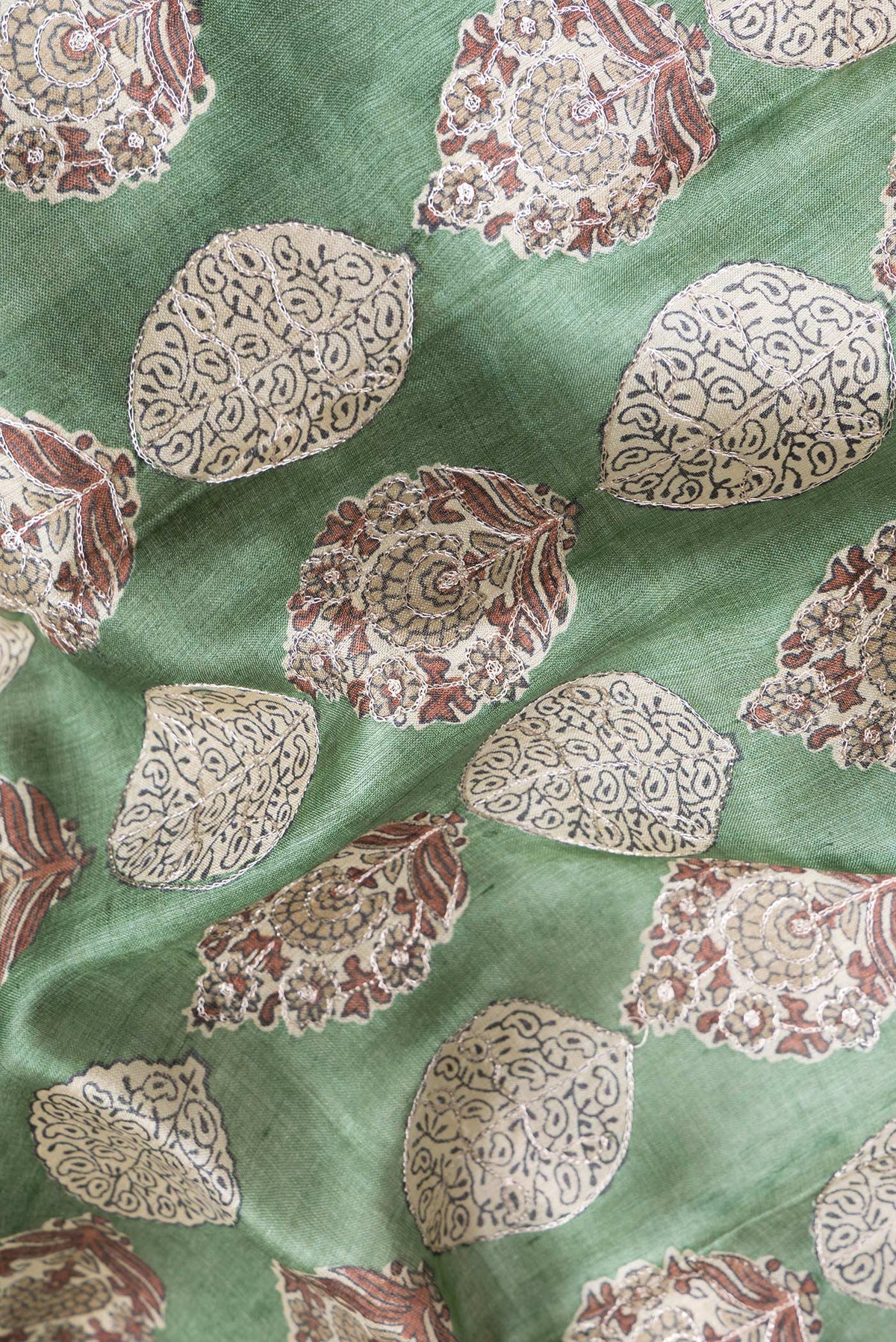 Close up of Green Dual Tone Tussar Silk Saree with Embroidery on the body and Zari Border.  displaying folds