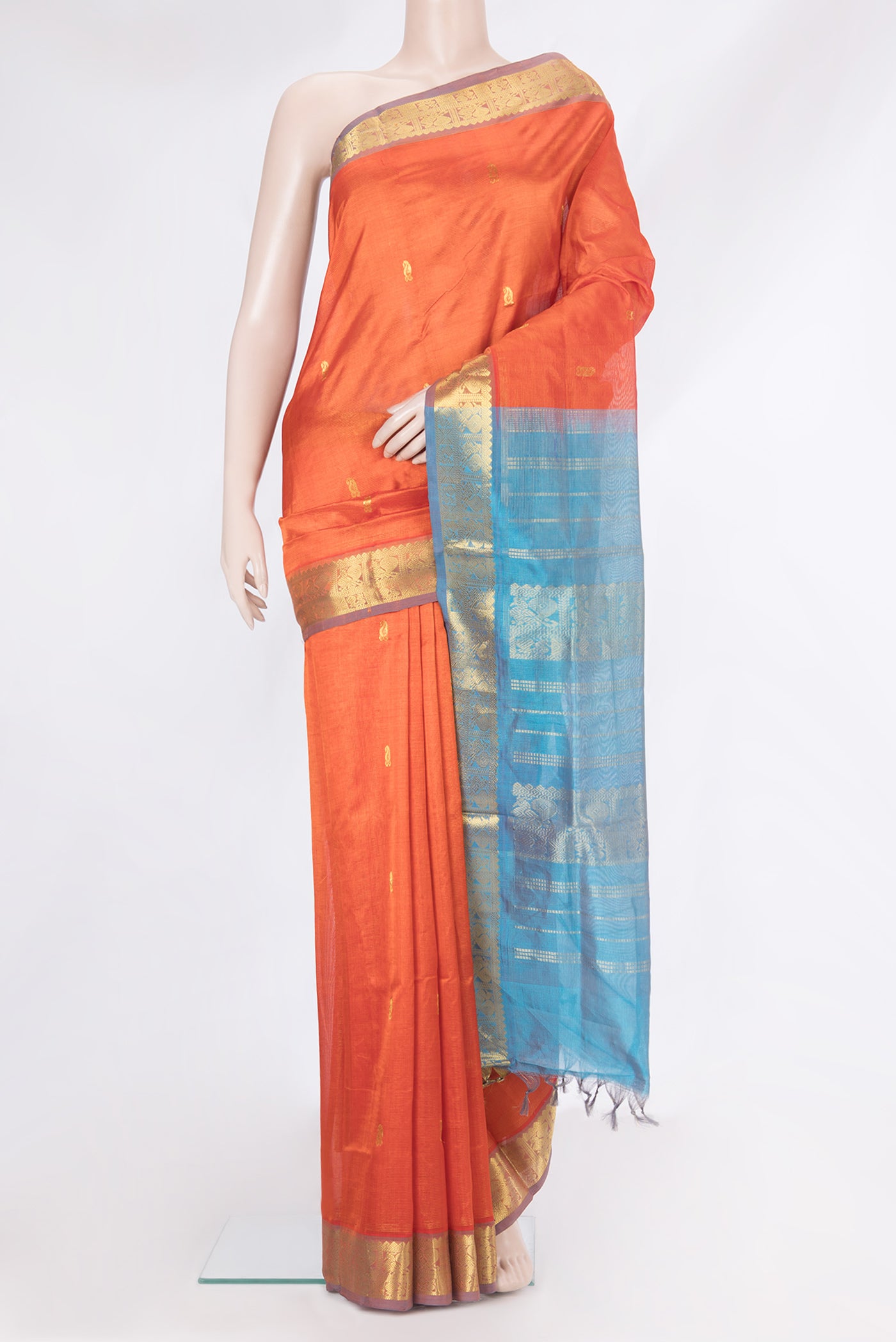 Orange Silk Cotton Saree with Zari Butta on the body and Zari Border.  displayed on a mannequin