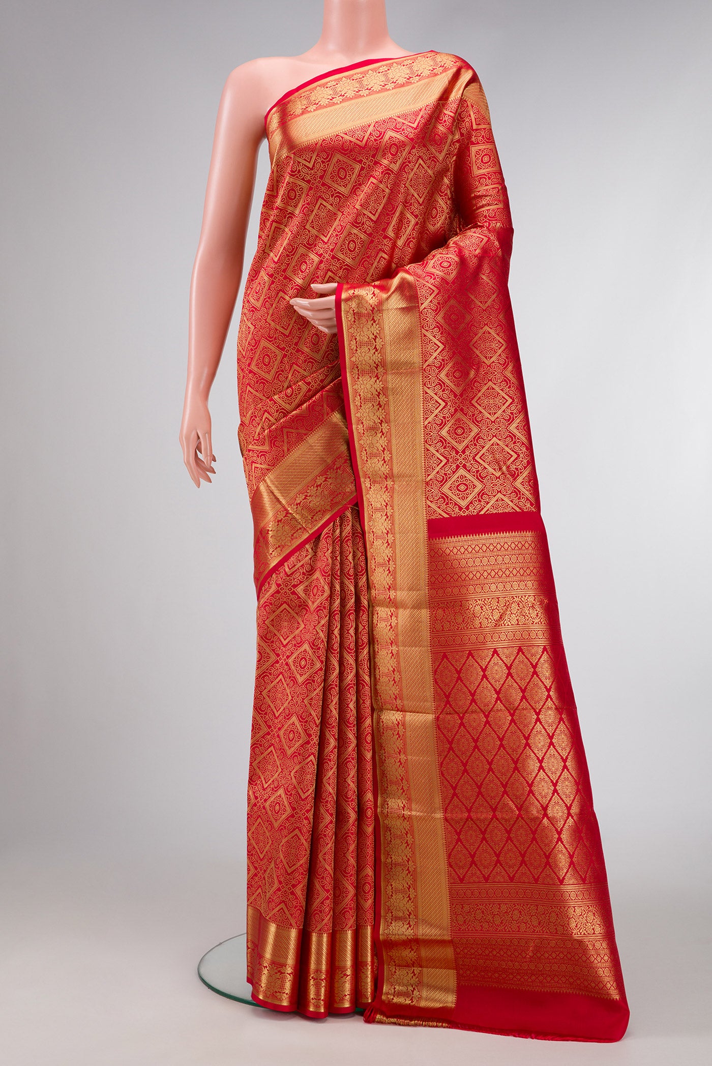 Red Dual Tone Kanchipuram Silk Saree with Zari Brocade on the body and Zari Border.  displayed on a mannequin