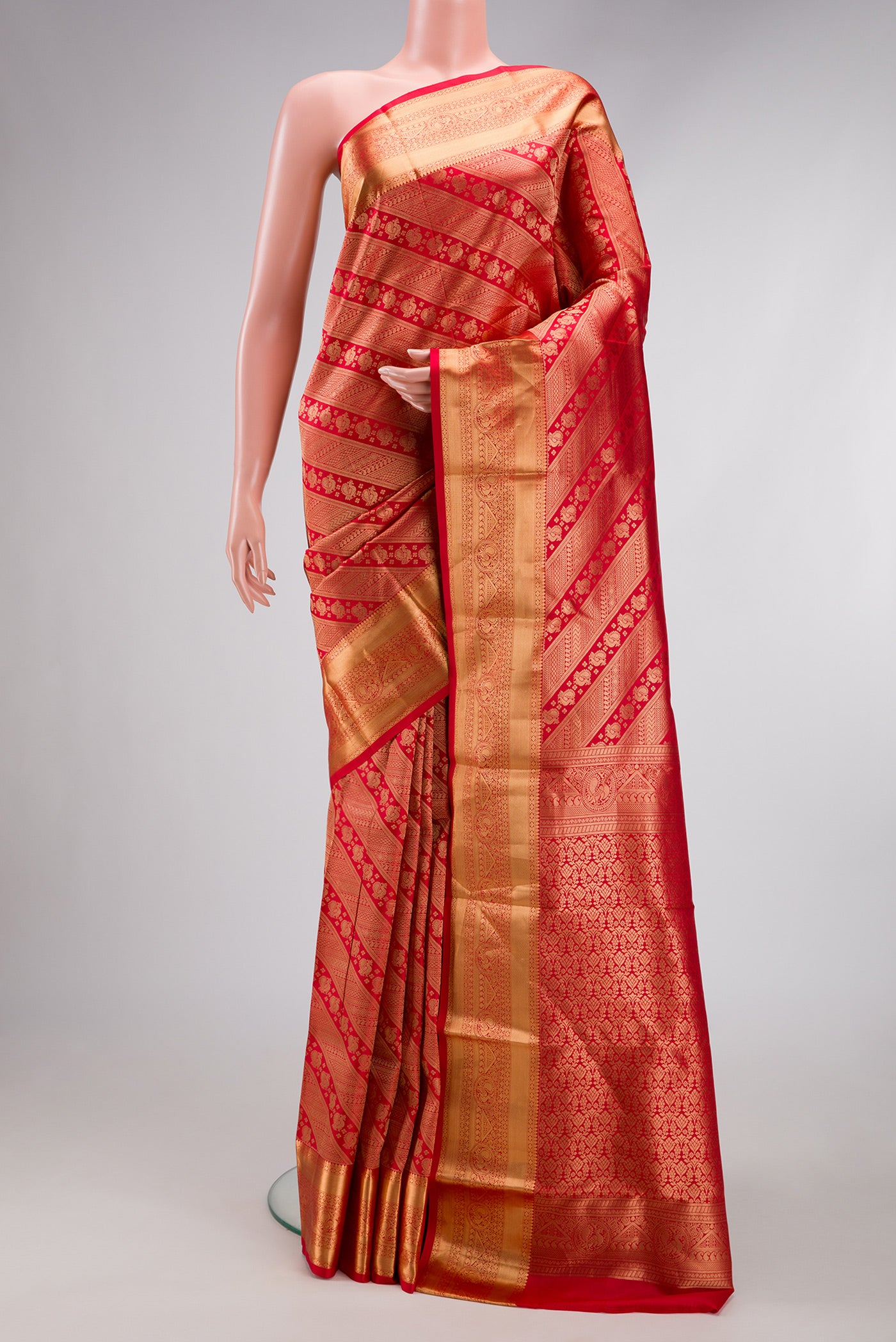 Red Kanchipuram Silk Saree with Zari Brocade on the body and Zari Border.  displayed on a mannequin