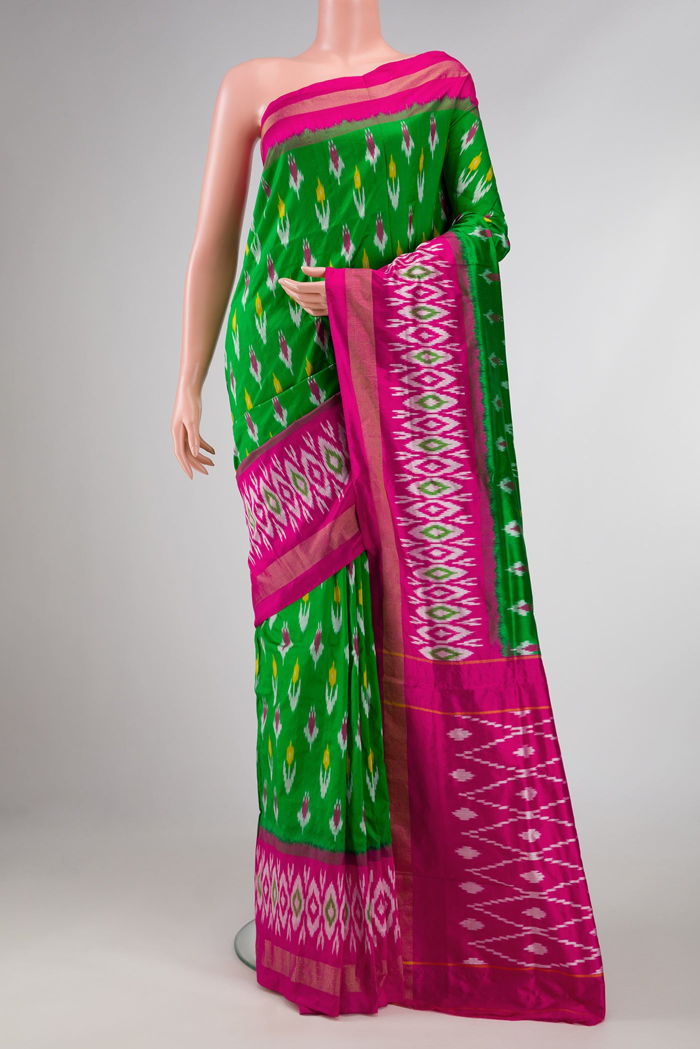 Green Pochampally Silk Saree with Ikat Print on the body and Ikat Border displayed on a mannequin