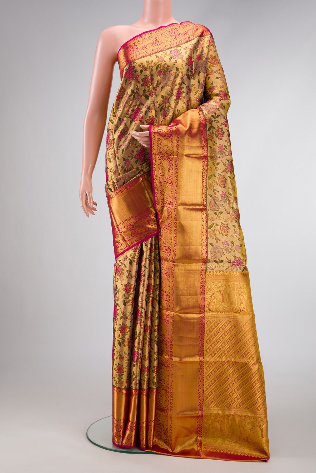Gold Dual Tone Kanjivaram Tissue Silk Saree with Zari Brocade on the body and Zari Border.  displayed on a mannequin
