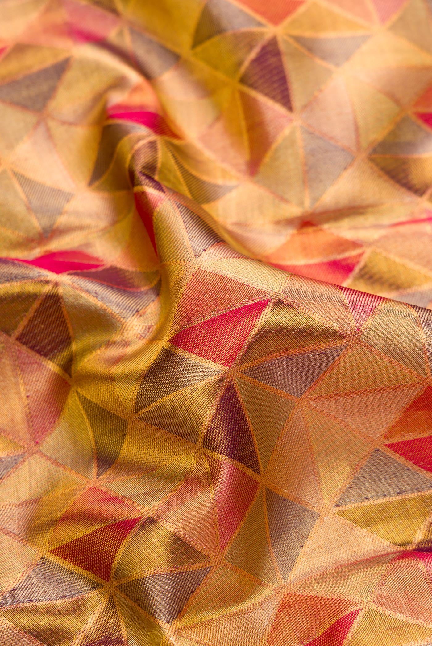 Close up of Gold Dual Tone Kanjivaram Tissue Silk Saree with Zari Brocade on the body and Zari Border.  displaying folds
