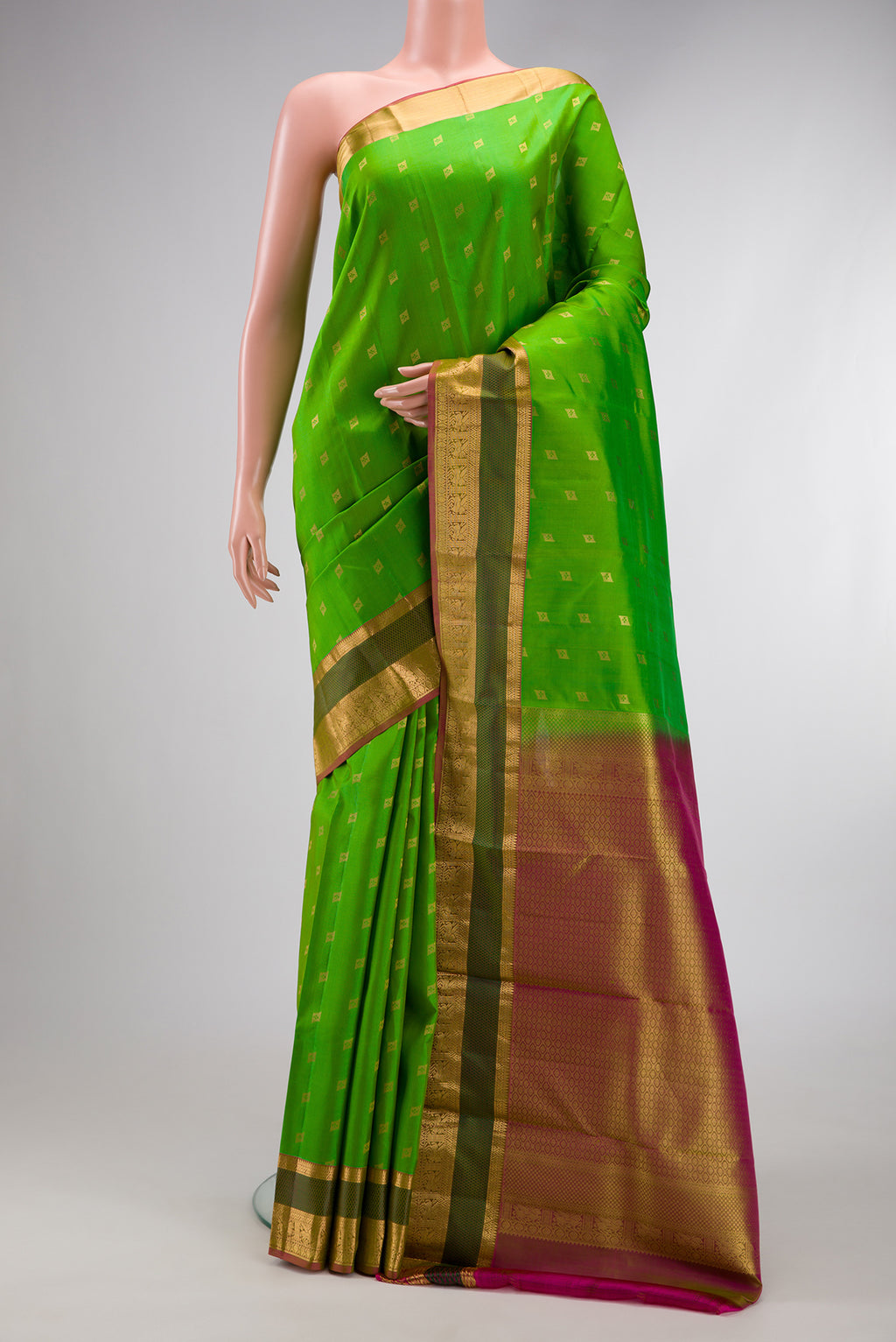 Parrot Green Dual Tone Kanchipuram Silk Saree with Zari Butta on the body and Zari And Thread Border.  displayed on a mannequin