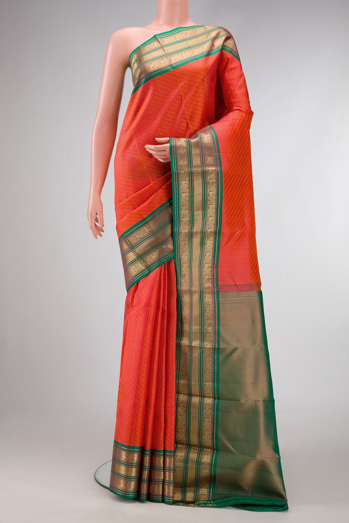 Orange Dual Tone Kanchipuram Silk Saree with Jacquard design on the body and Zari Border.  displayed on a mannequin