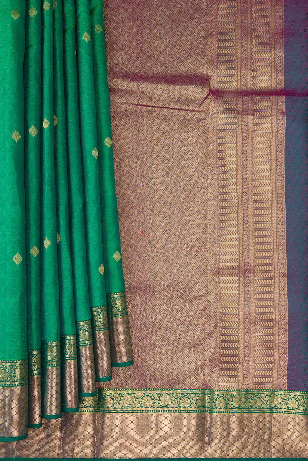 Pleats and pallu of Green Kanchipuram Silk Saree with Jacquard With Zari Butta on the body and Zari Border. 