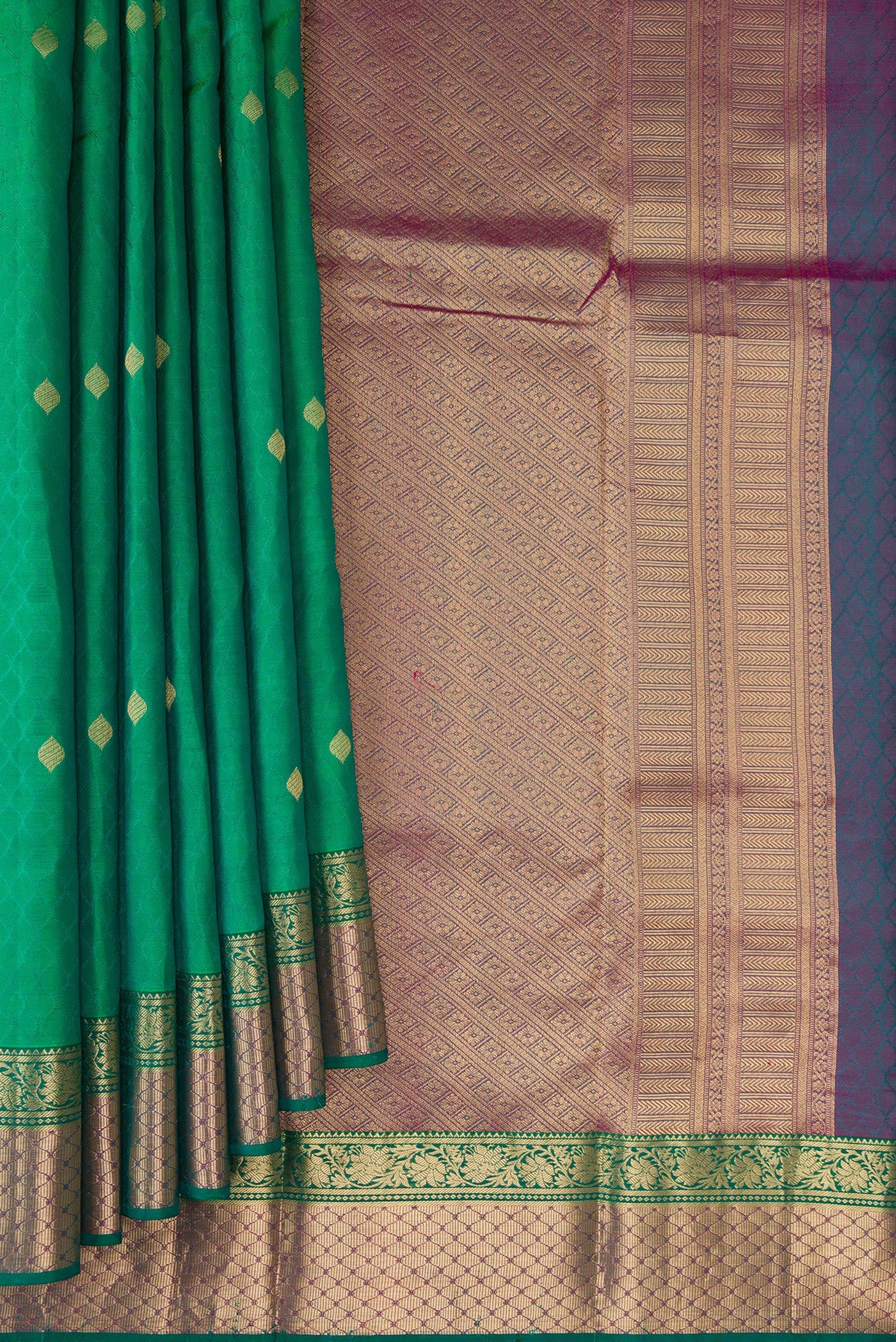Pleats and pallu of Green Kanchipuram Silk Saree with Jacquard With Zari Butta on the body and Zari Border. 
