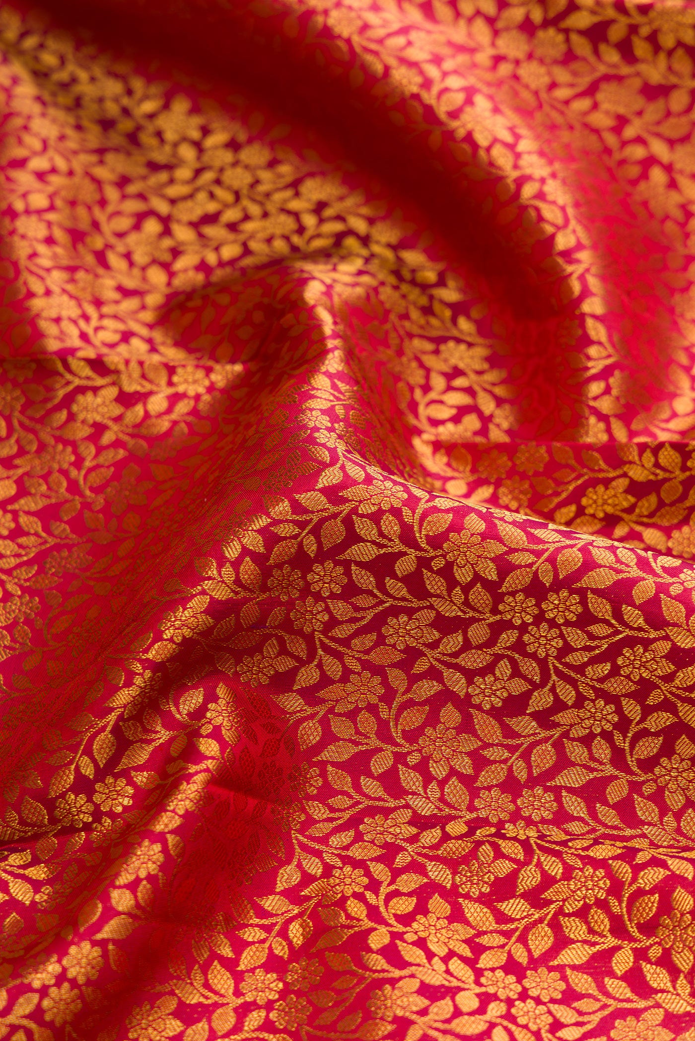 Close up of Maroon Dual Tone Kanchipuram Silk Saree with Zari Brocade on the body and Zari Border.  displaying folds