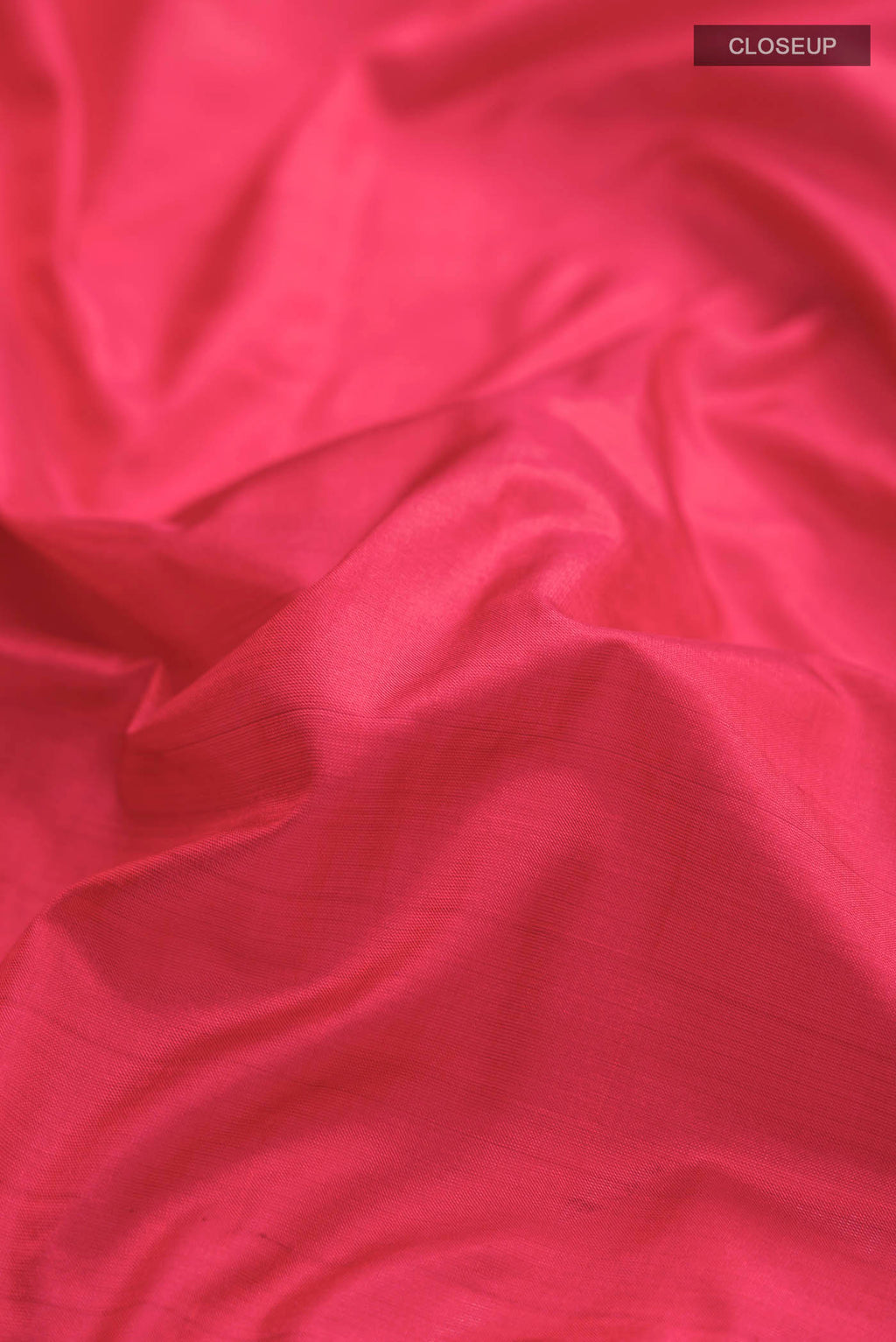 Close up of Red Kanchipuram Silk Saree with Plain Body and Zari Border displaying folds