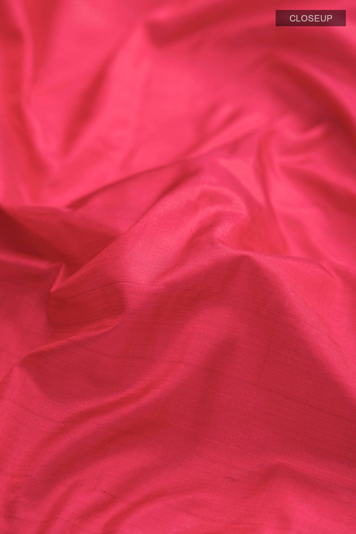 Close up of Red Kanchipuram Silk Saree with Plain Body and Zari Border displaying folds