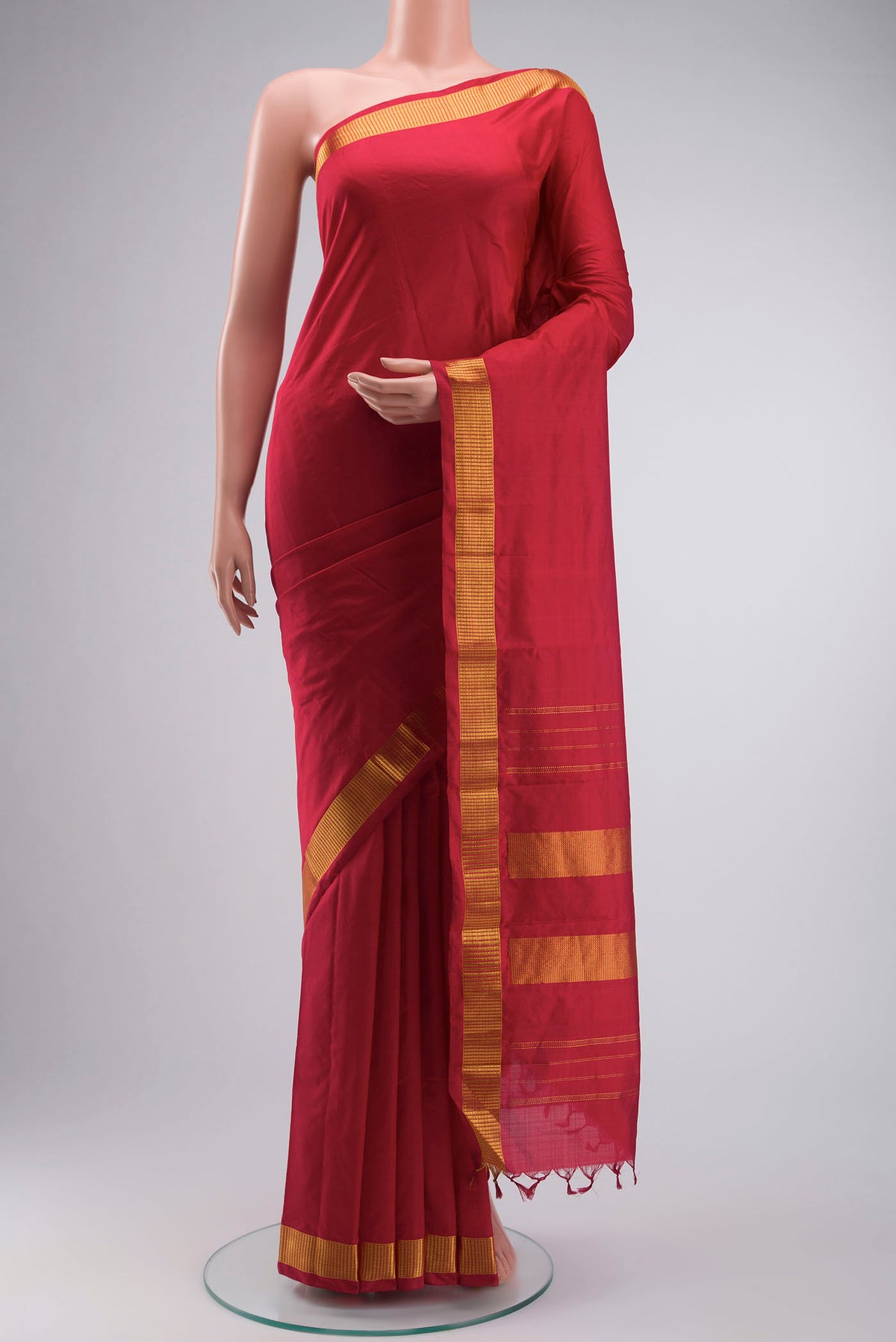 Red Kanchipuram Silk Saree with Plain Body and Zari Border displayed on a mannequin
