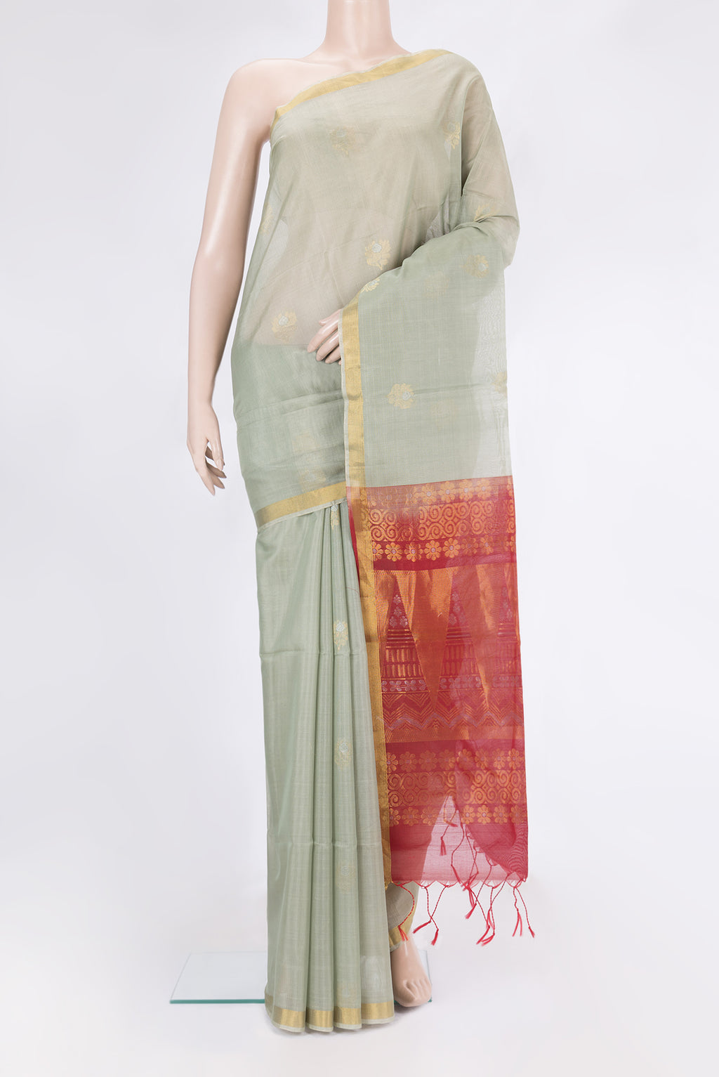 Light Green Silk Cotton Saree with Zari Butta on the body and Zari Border.  displayed on a mannequin