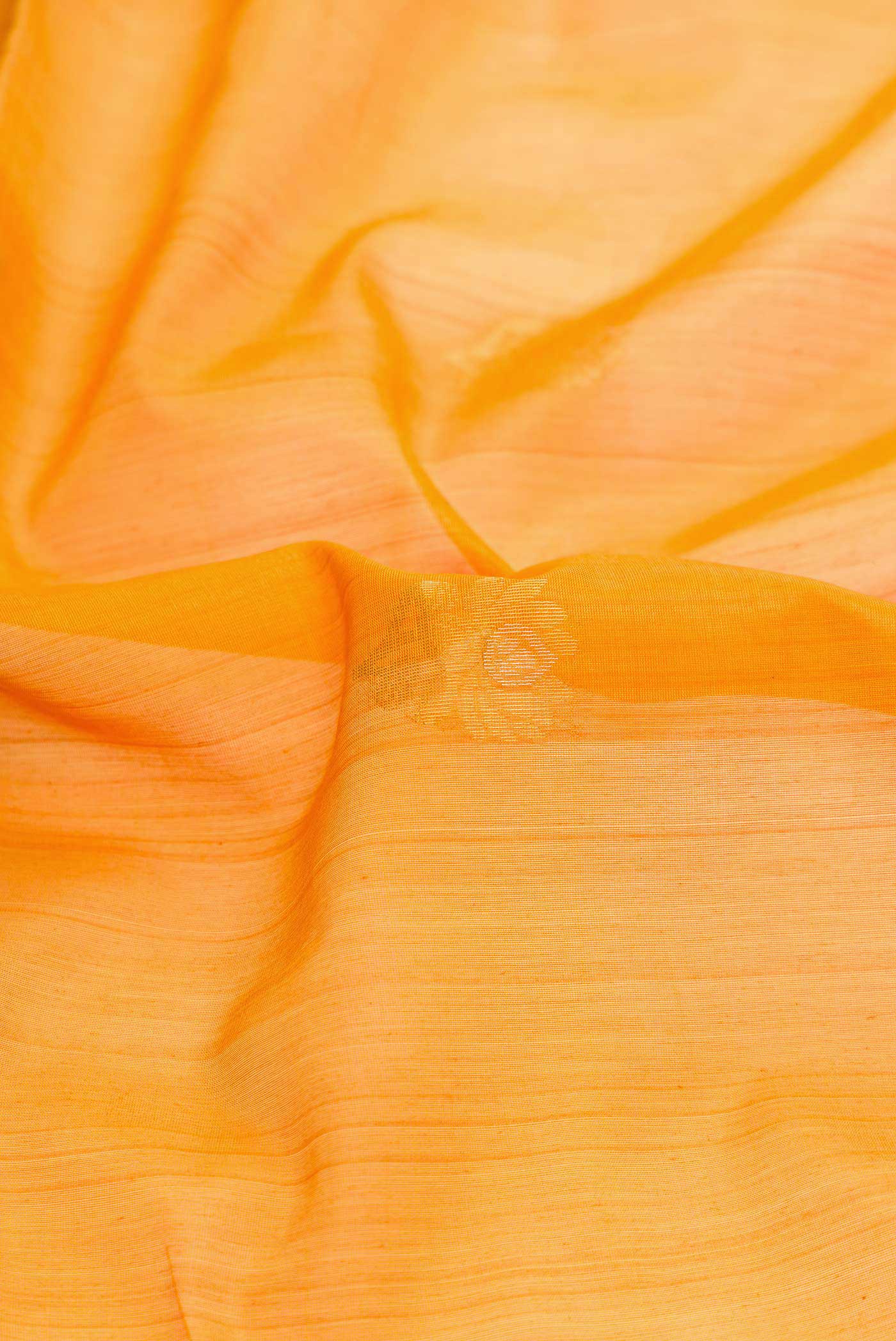 Close up of Mustard Dual Tone Silk Cotton Saree with Zari Butta on the body and Zari Border displaying folds