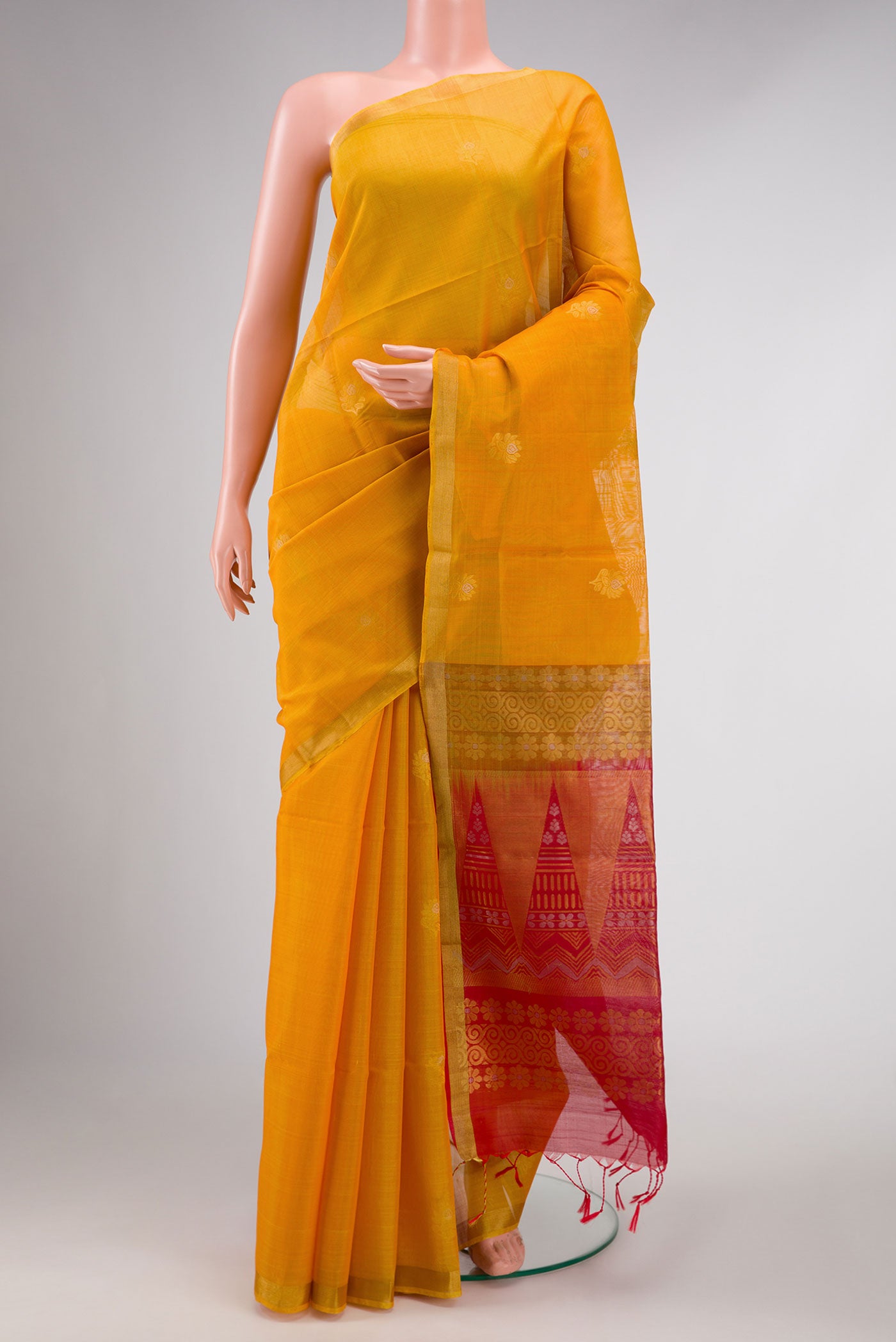 Mustard Dual Tone Silk Cotton Saree with Zari Butta on the body and Zari Border displayed on a mannequin