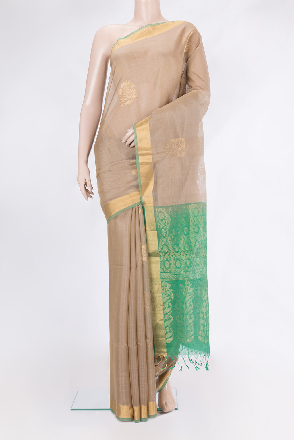 Dark Beige Silk Cotton Saree with Zari Butta on the body and Zari Border.  displayed on a mannequin