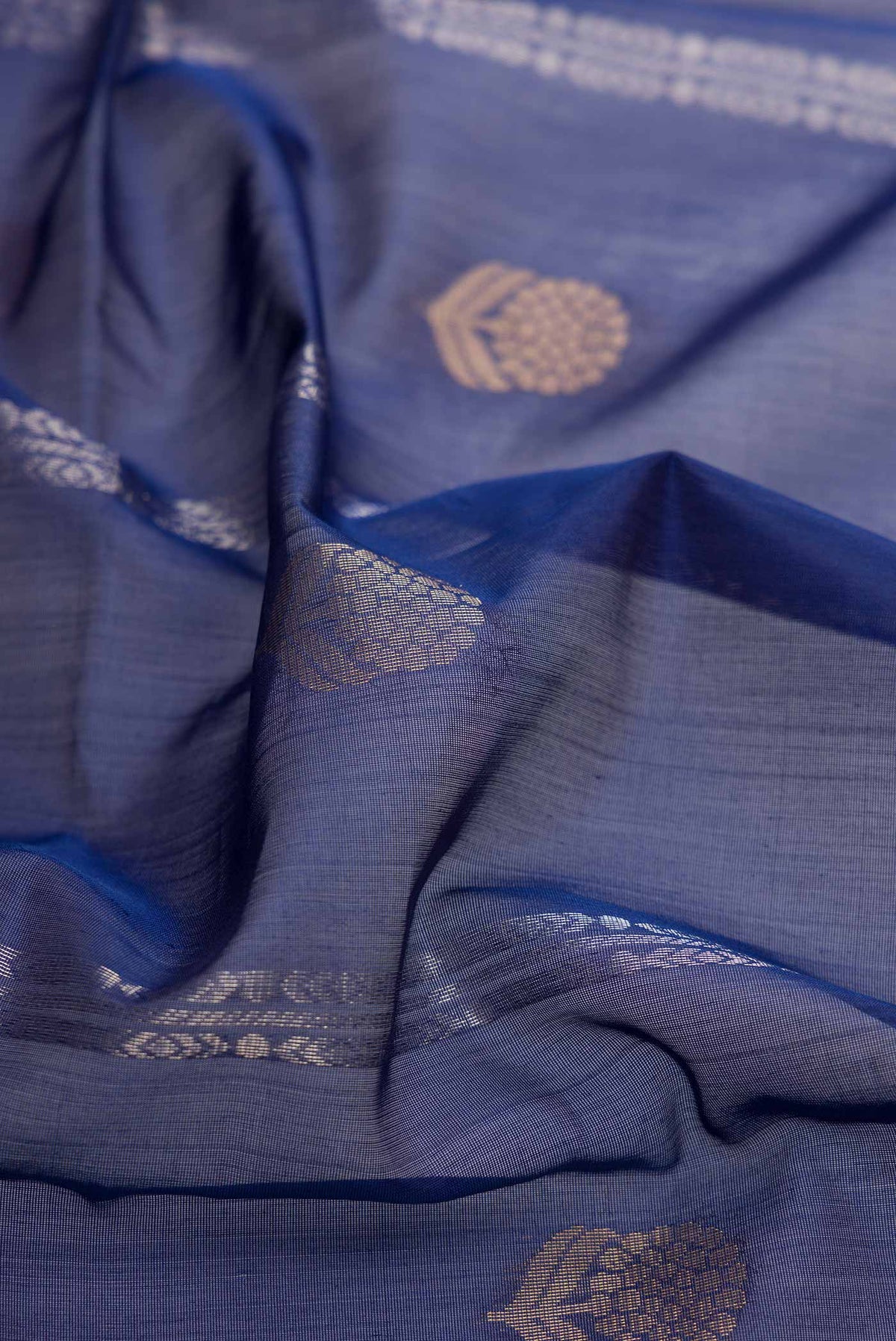 Close up of Navy Blue Dual Tone Silk Cotton Saree with Zari Butta on the body and Zari Border displaying folds