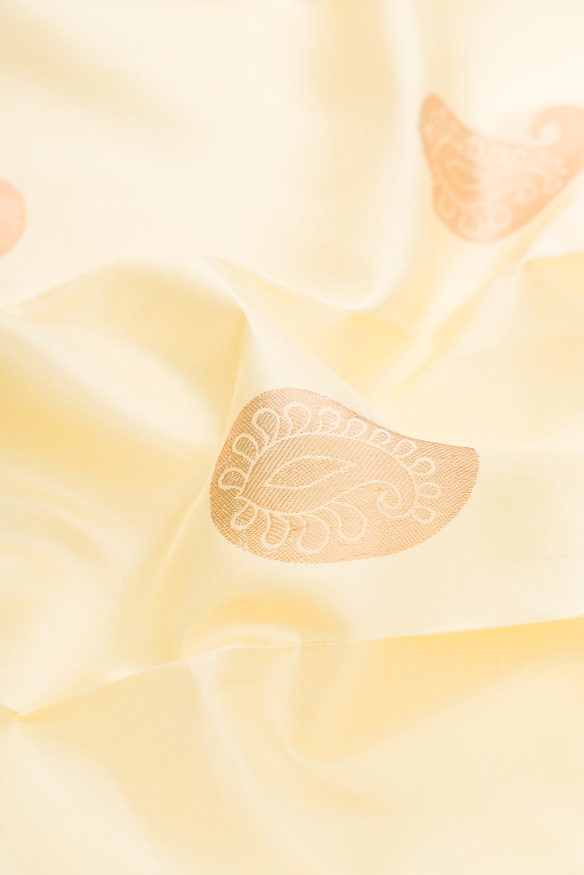 Close up of Sandal Dual Tone Kanjivaram Silk Saree with Zari Butta on the body and Zari Border.  displaying folds