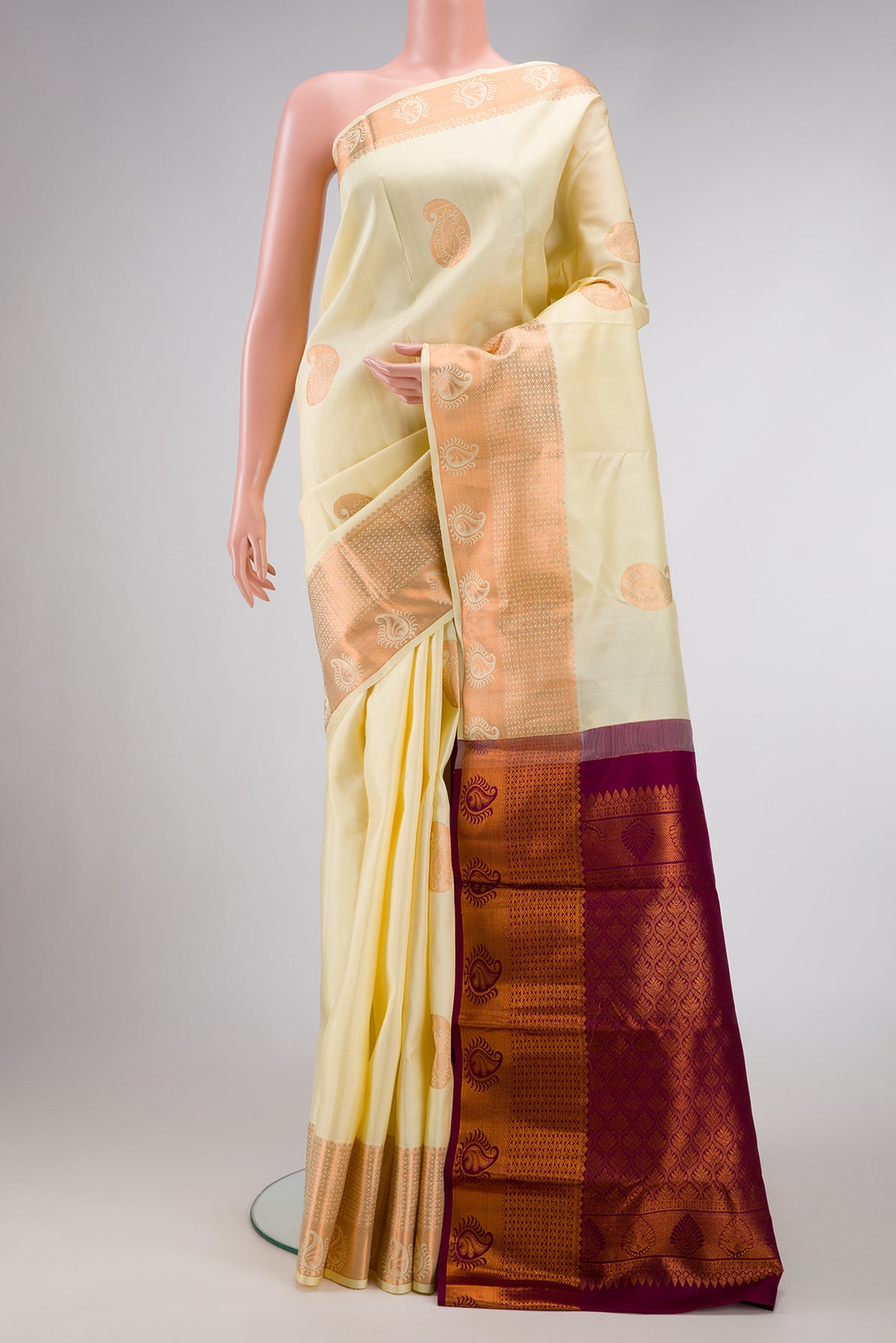 Sandal Dual Tone Kanjivaram Silk Saree with Zari Butta on the body and Zari Border.  displayed on a mannequin