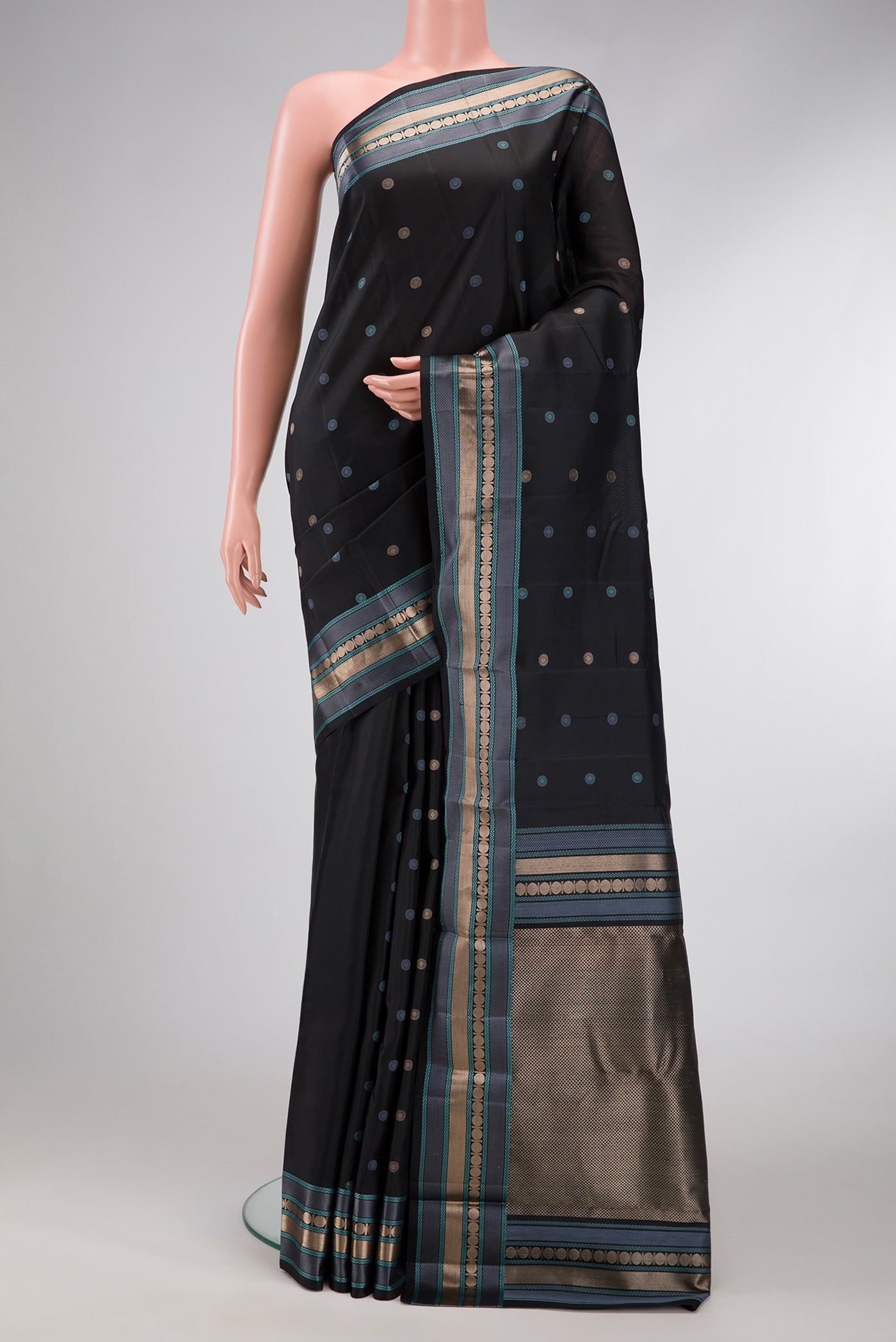 Black Dual Tone Kanchipuram Silk Saree with Zari And Thread Butta on the body and Zari And Thread Border.  displayed on a mannequin