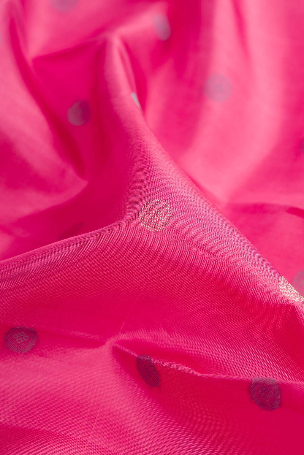 Close up of Pink Dual Tone Kanchipuram Silk Saree with Zari And Thread Butta on the body and Zari Border.  displaying folds