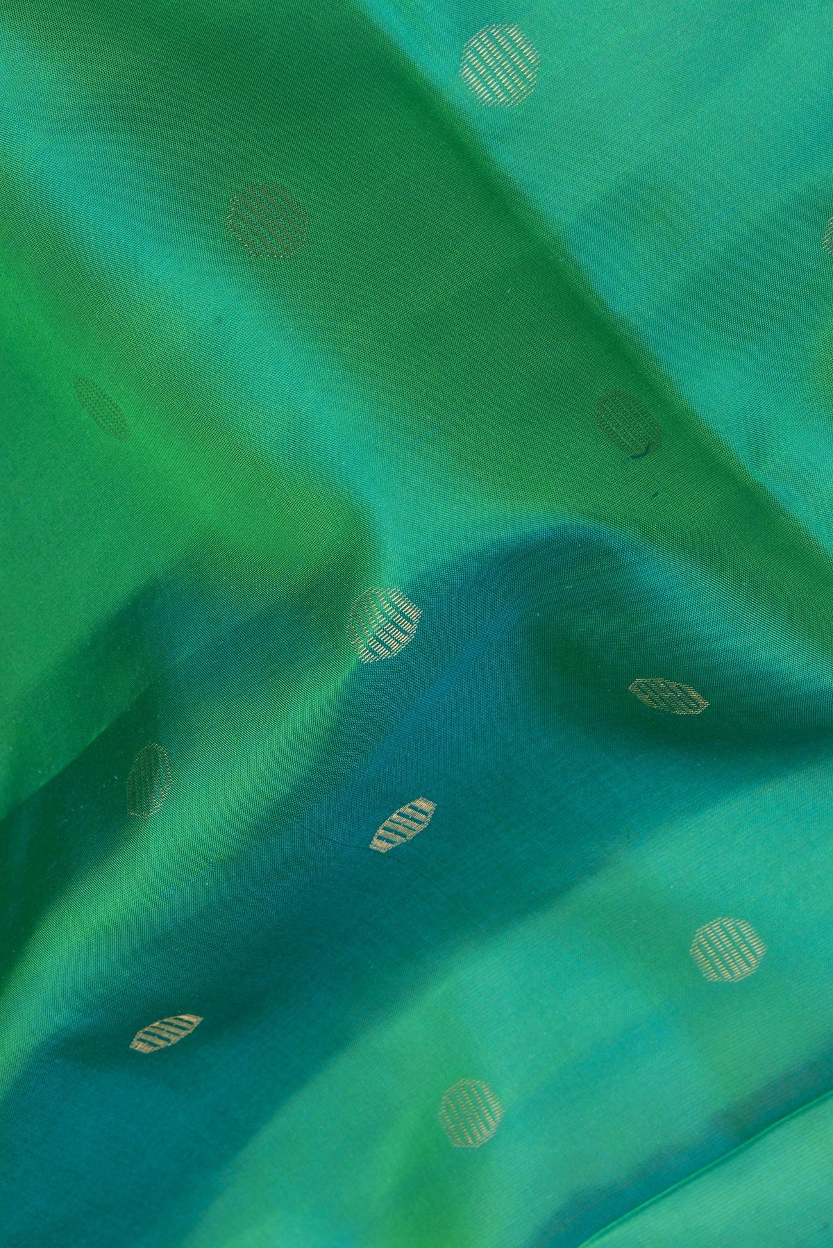 Close up of Pure Silk Sea Green Dual Tone Soft Saree with Zari Butta on the body and Zari Border.  displaying folds