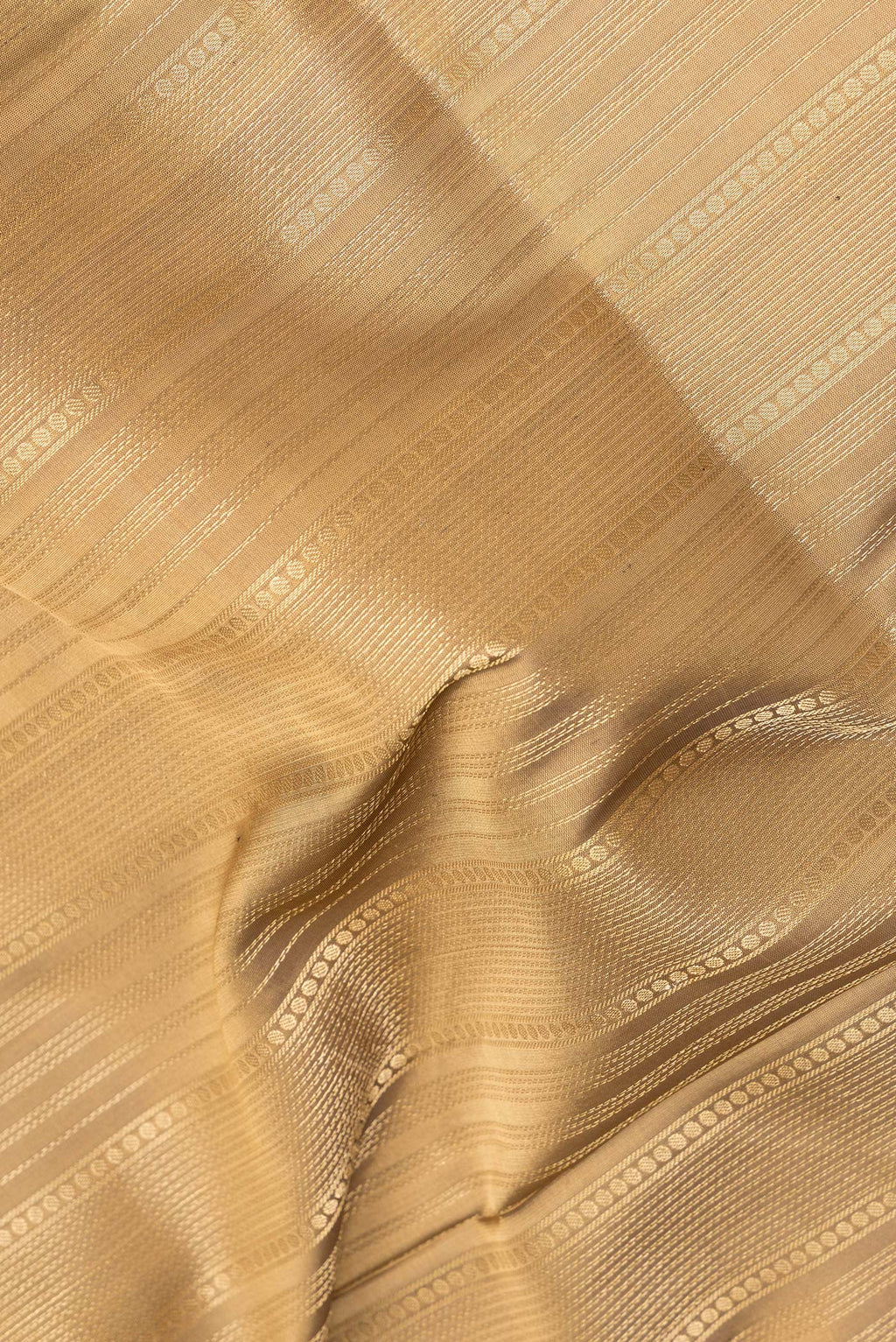 Close up of Pure Silk Brown Soft Saree with Stripes on the body and Zari Border.  displaying folds