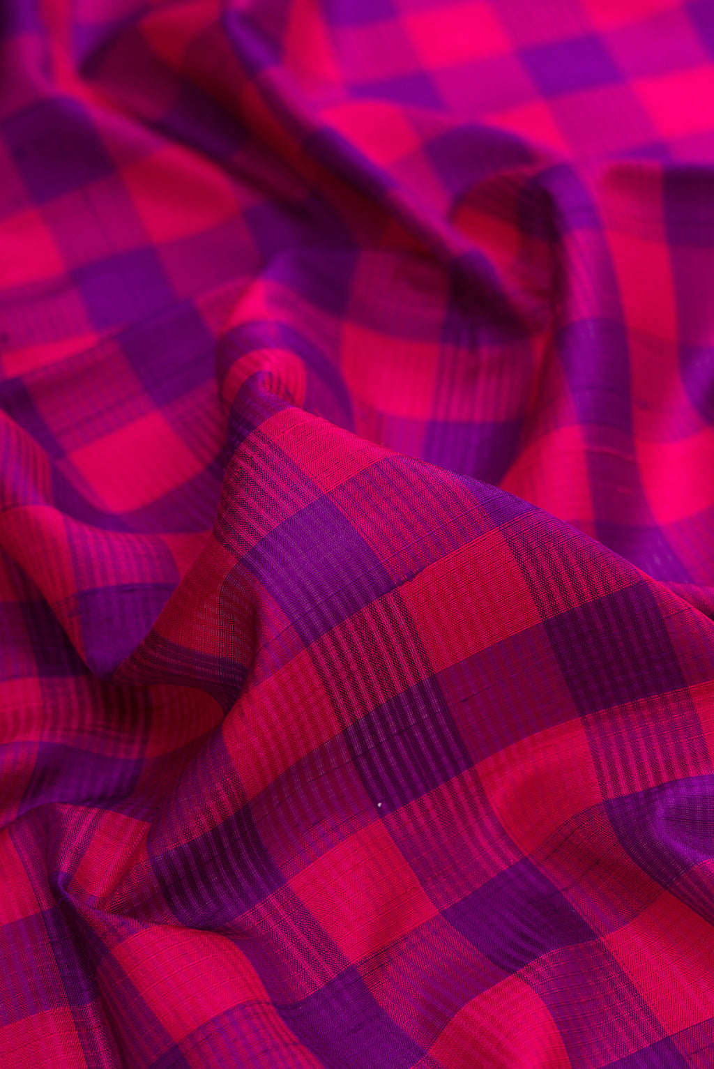 Close up of Pure Silk Multi Color Soft Saree with Checked design on the body and Zari Border.  displaying folds