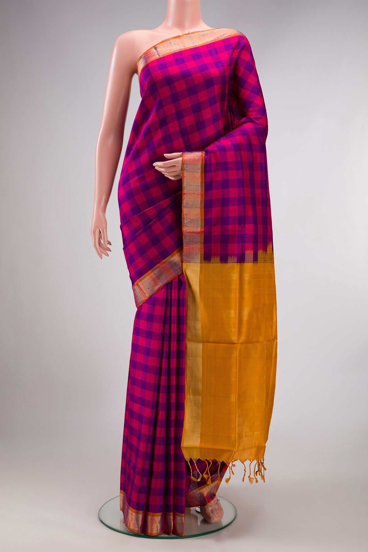 Pure Silk Multi Color Soft Saree with Checked design on the body and Zari Border.  displayed on a mannequin