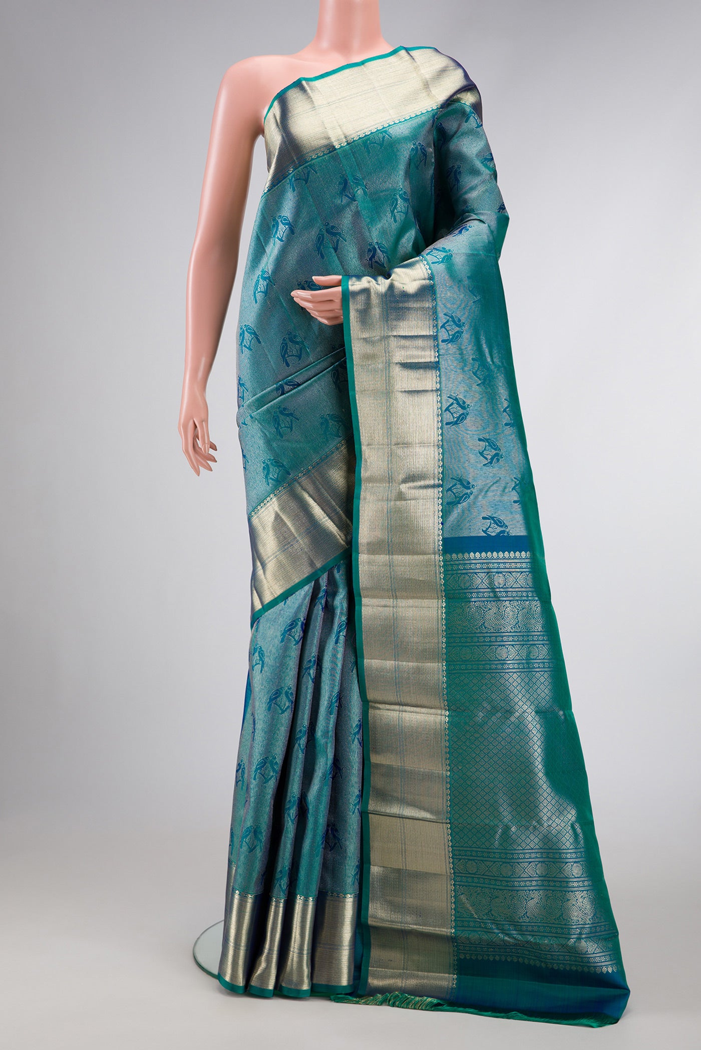 Peacock Blue Dual Tone Kanchipuram Silk Saree with Zari Brocade on the body and Zari Border.  displayed on a mannequin