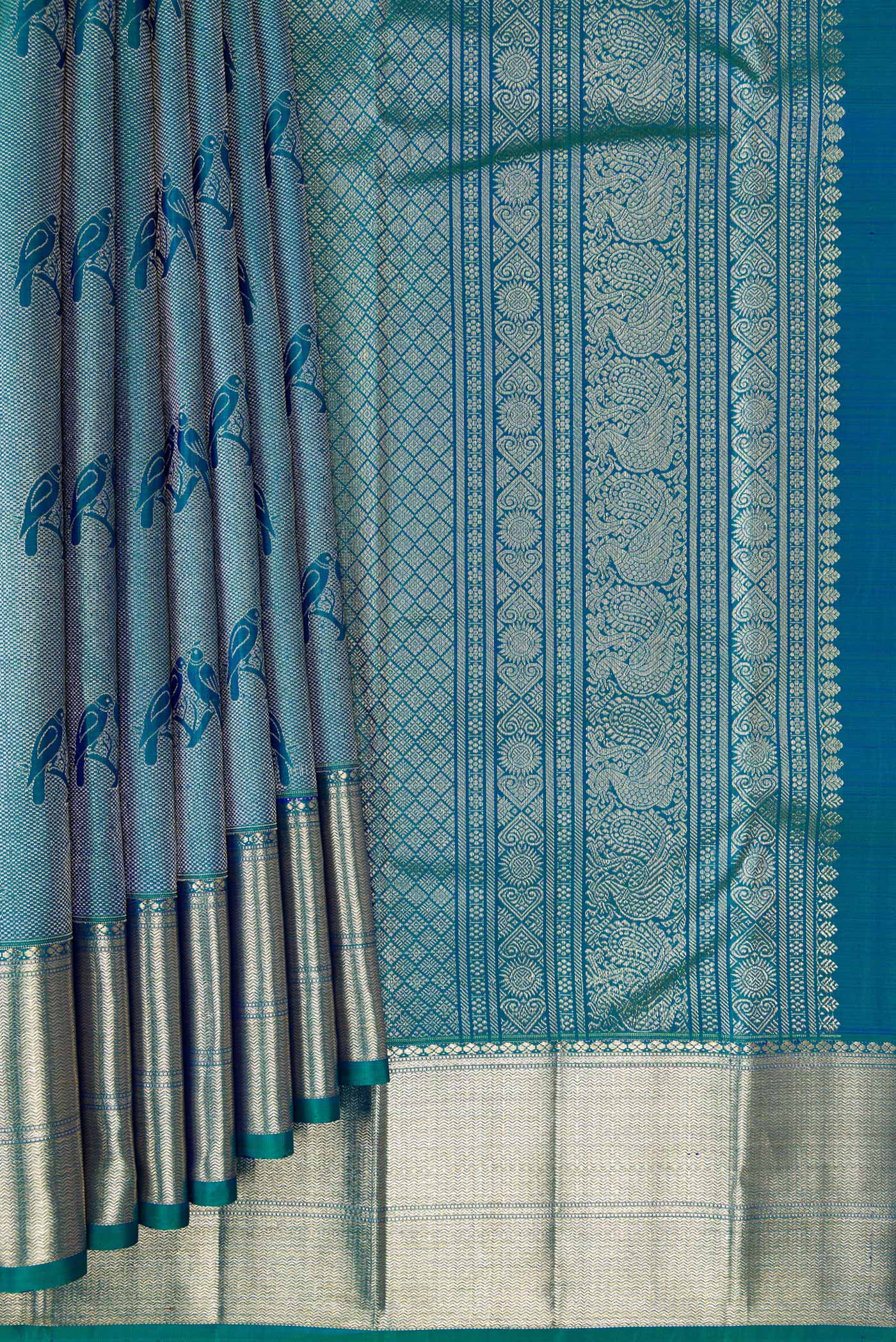 Pleats and pallu of Peacock Blue Dual Tone Kanchipuram Silk Saree with Zari Brocade on the body and Zari Border. 