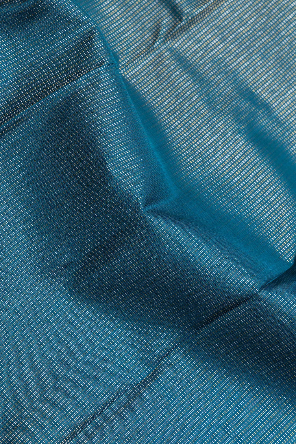 Close up of Peacock Blue Dual Tone Kanchipuram Silk Saree with Stripes on the body and Zari Border.  displaying folds