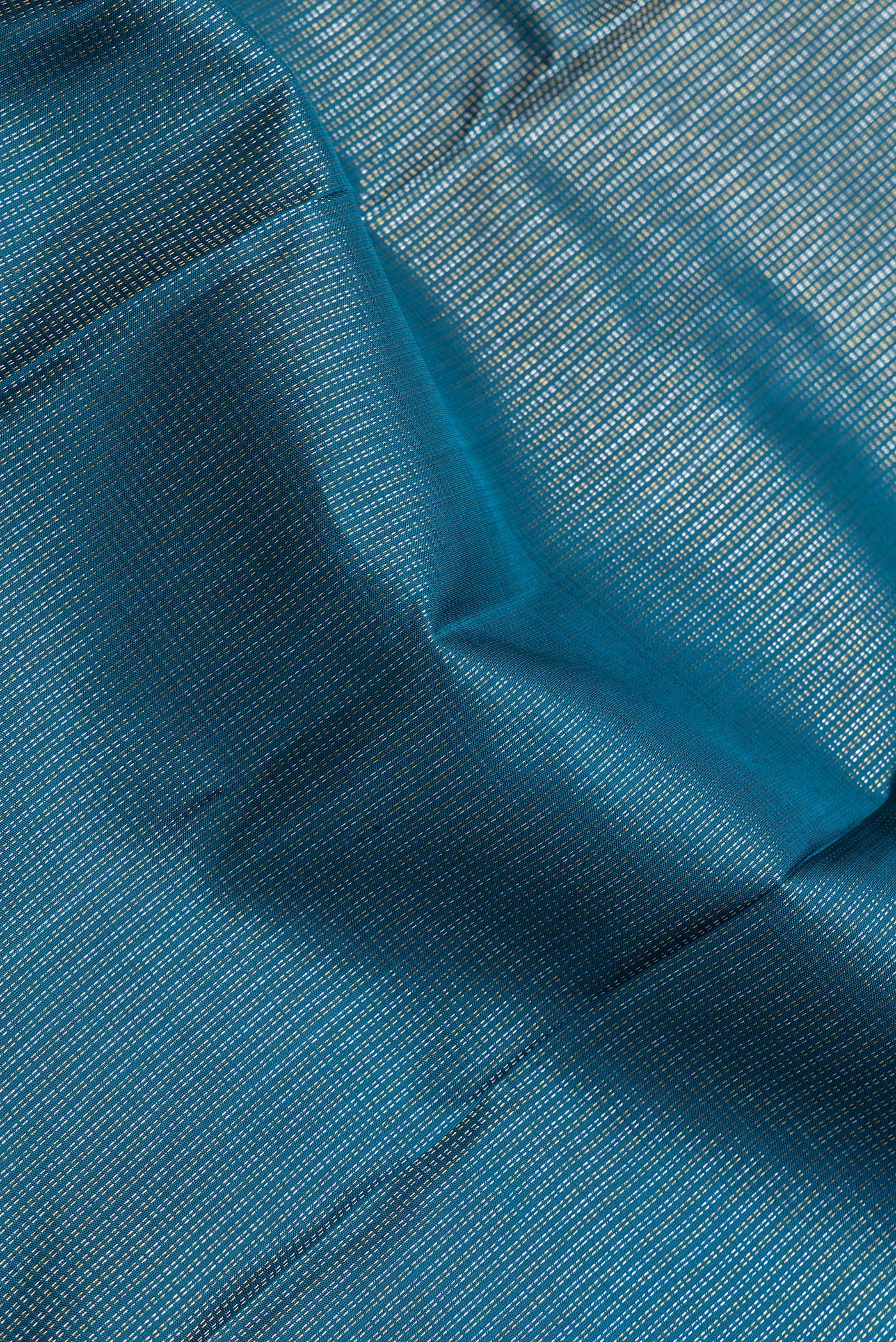 Close up of Peacock Blue Dual Tone Kanchipuram Silk Saree with Stripes on the body and Zari Border.  displaying folds