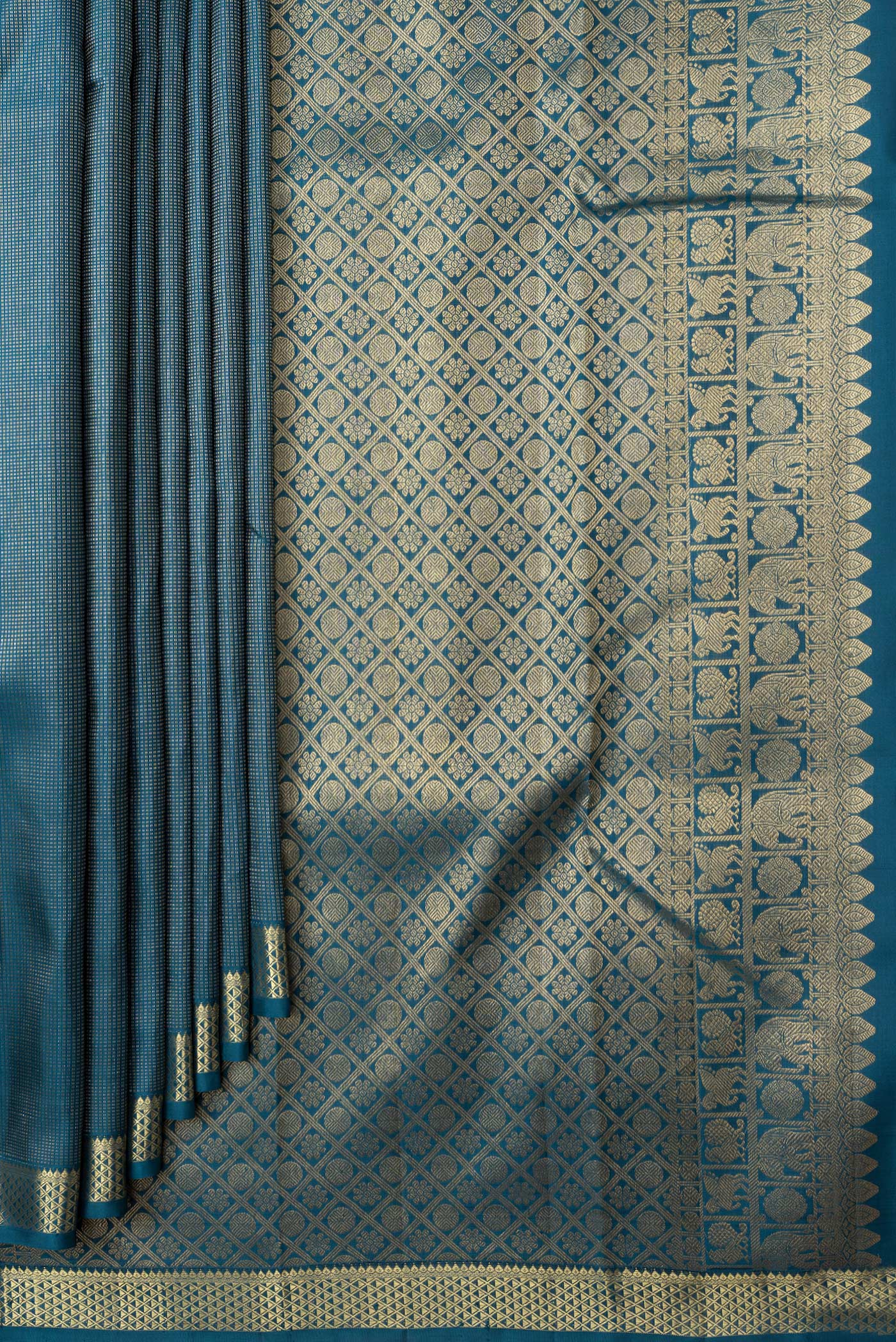 Pleats and pallu of Peacock Blue Dual Tone Kanchipuram Silk Saree with Stripes on the body and Zari Border. 