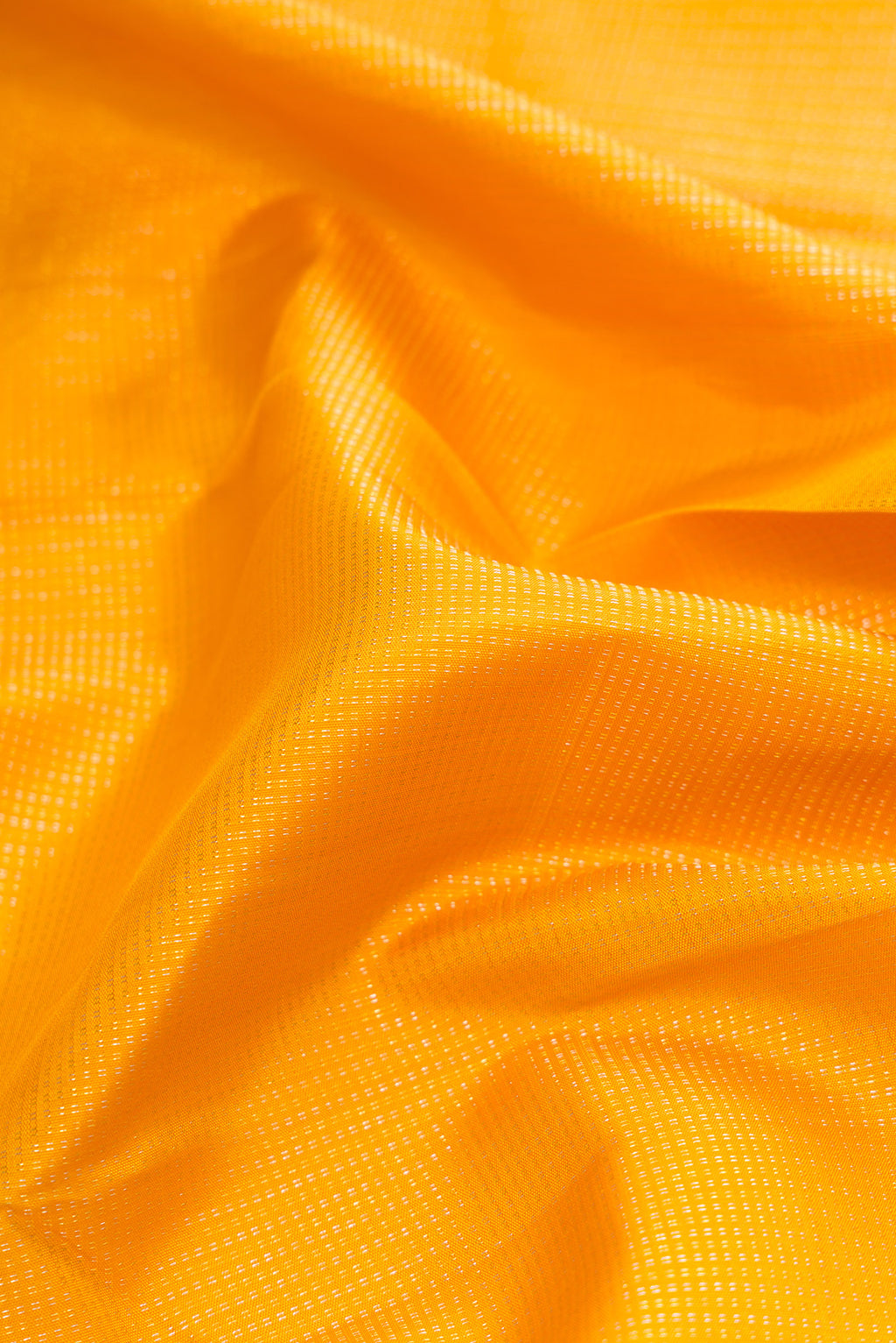 Close up of Mustard Dual Tone Kanchipuram Silk Saree with Stripes on the body and Zari Border.  displaying folds
