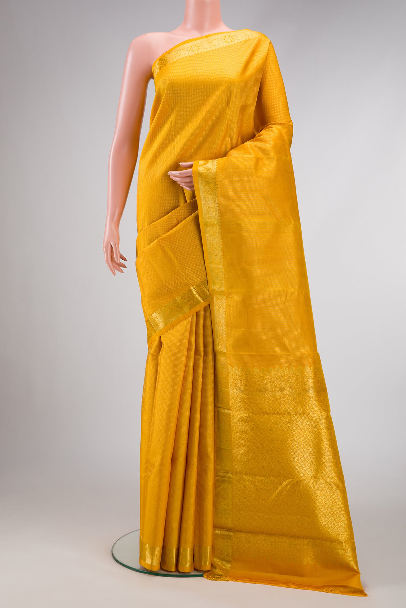Mustard Dual Tone Kanchipuram Silk Saree with Stripes on the body and Zari Border.  displayed on a mannequin