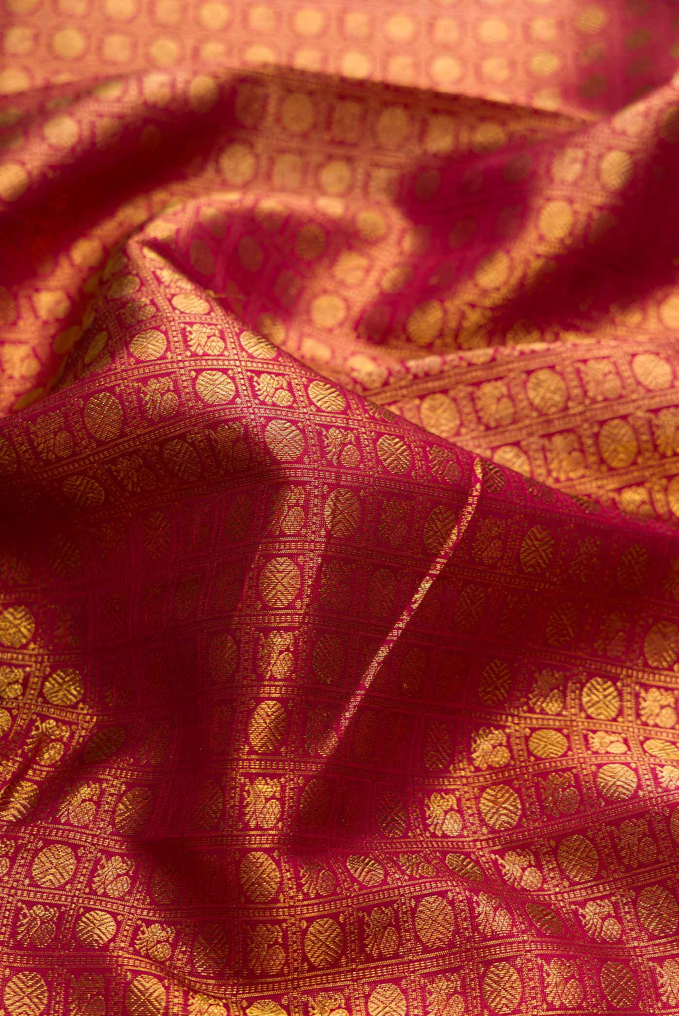 Close up of Maroon Dual Tone Kanchipuram Silk Saree with Zari Brocade on the body and Zari Border displaying folds