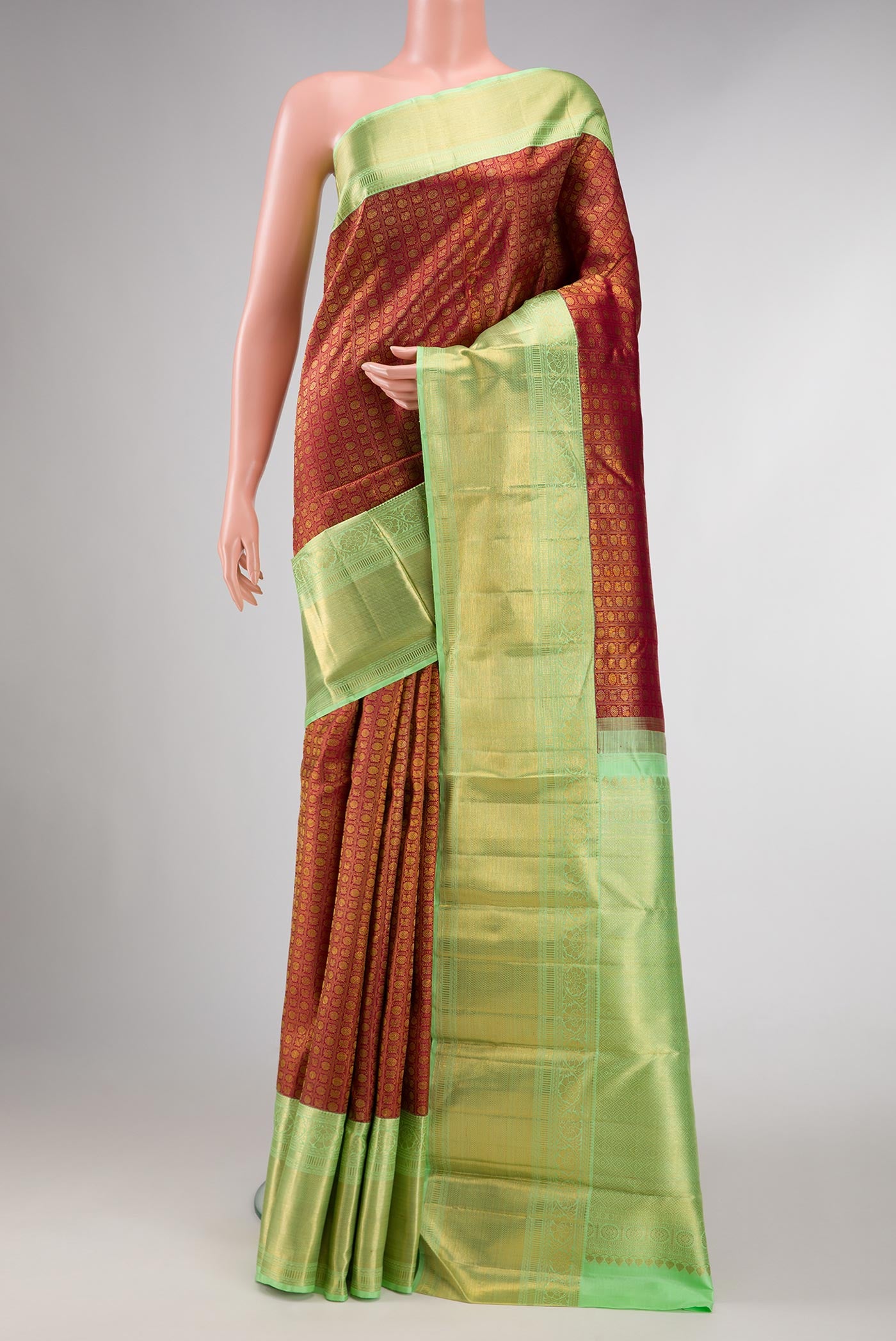 Maroon Dual Tone Kanchipuram Silk Saree with Zari Brocade on the body and Zari Border displayed on a mannequin